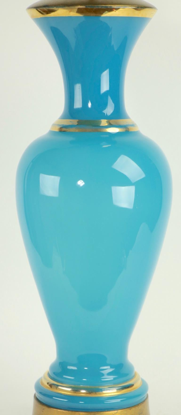 Striking blue opaline table lamp with gold trim. This impressive lamp is in very fine, original and working condition (rewired). It accepts two standard size screw in bulbs, shade not included. H to top of glass element 23 in x total H 37 in x