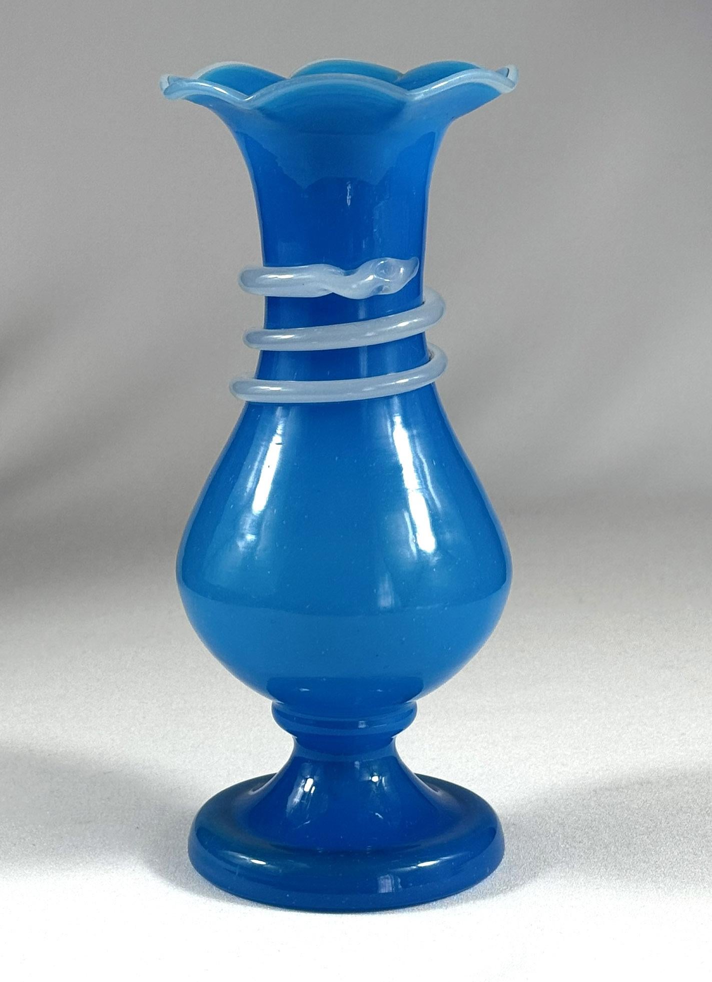 Interesting vase made of blue opaline glass with a white opaline glass spiral in the shape of a snake. The vase is hand-blown and most likely dates from the late 19th century or early 20th century. The vase is undamaged, a nice collector's item.