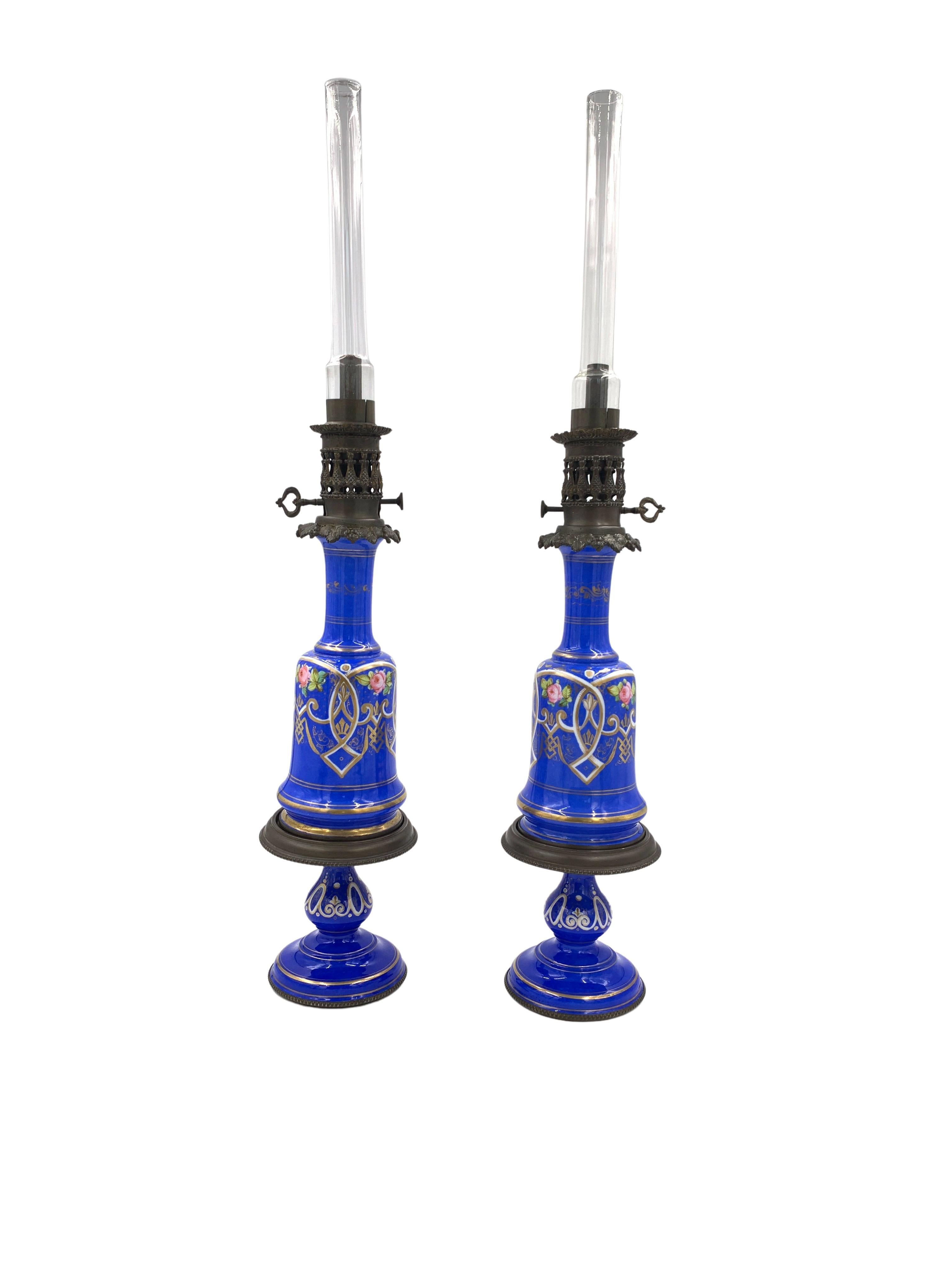 19th Century Blue Opaline glass oil lamps with gilt floral decoration.