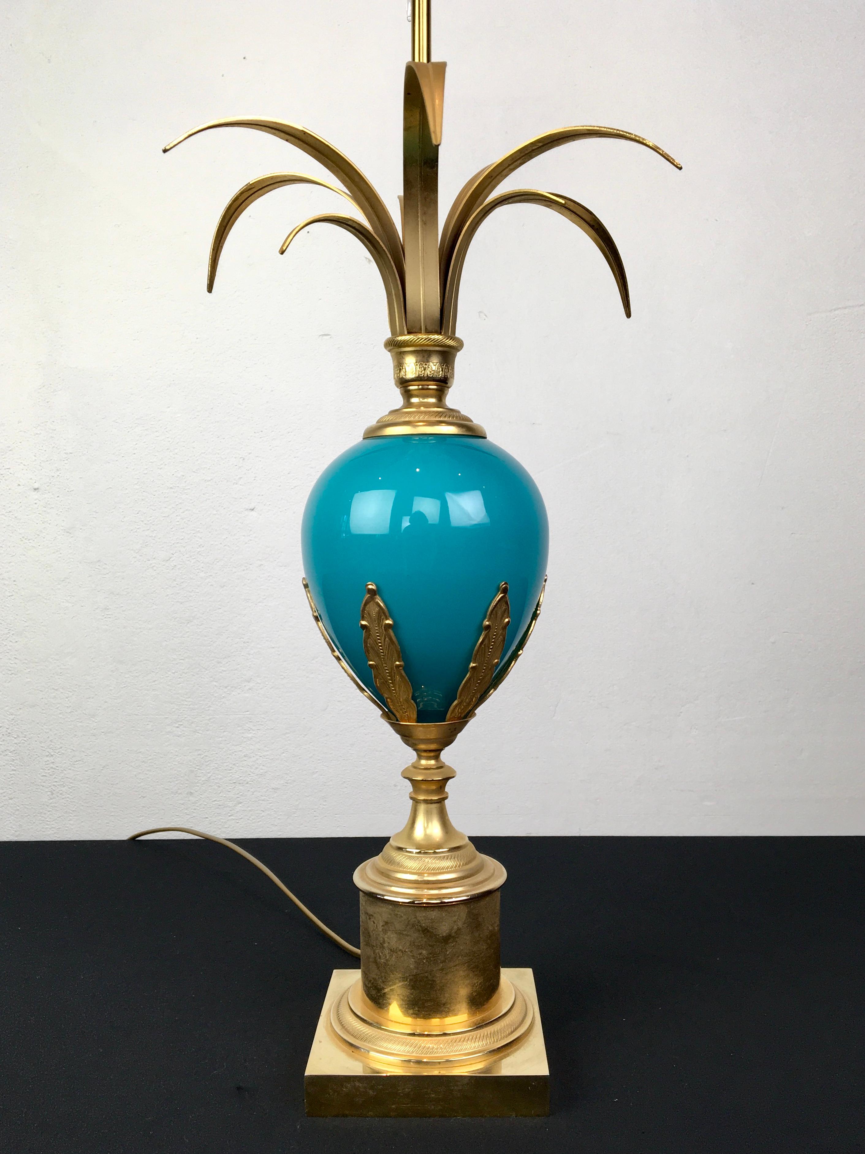 Blue turquoise ostrich egg table lamp by S.A. Boulanger. 
A stylish table lamp with a blue opaline ostrich egg and palm leaves on top. 
The base is made of brass with moulded brass leaves on the opal egg and it has a pine cone finish on top.