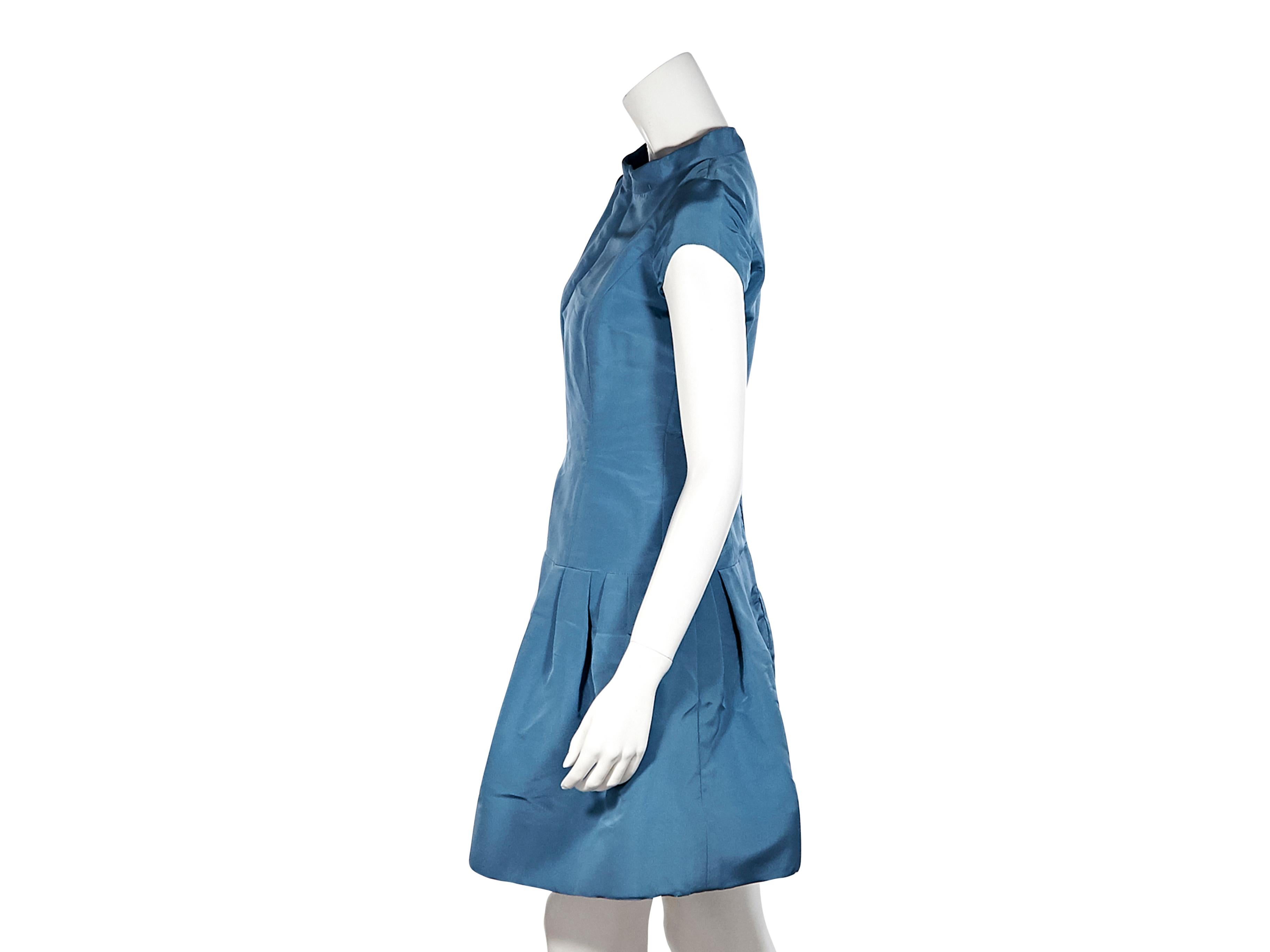 Product details:  Blue taffeta A-line mini dress by Oscar De La Renta.  Trimmed with lace. Bateau neckline. Cap sleeves. Drop waist. Concealed back zip closure. Style yours with long gold-tone earrings. 34