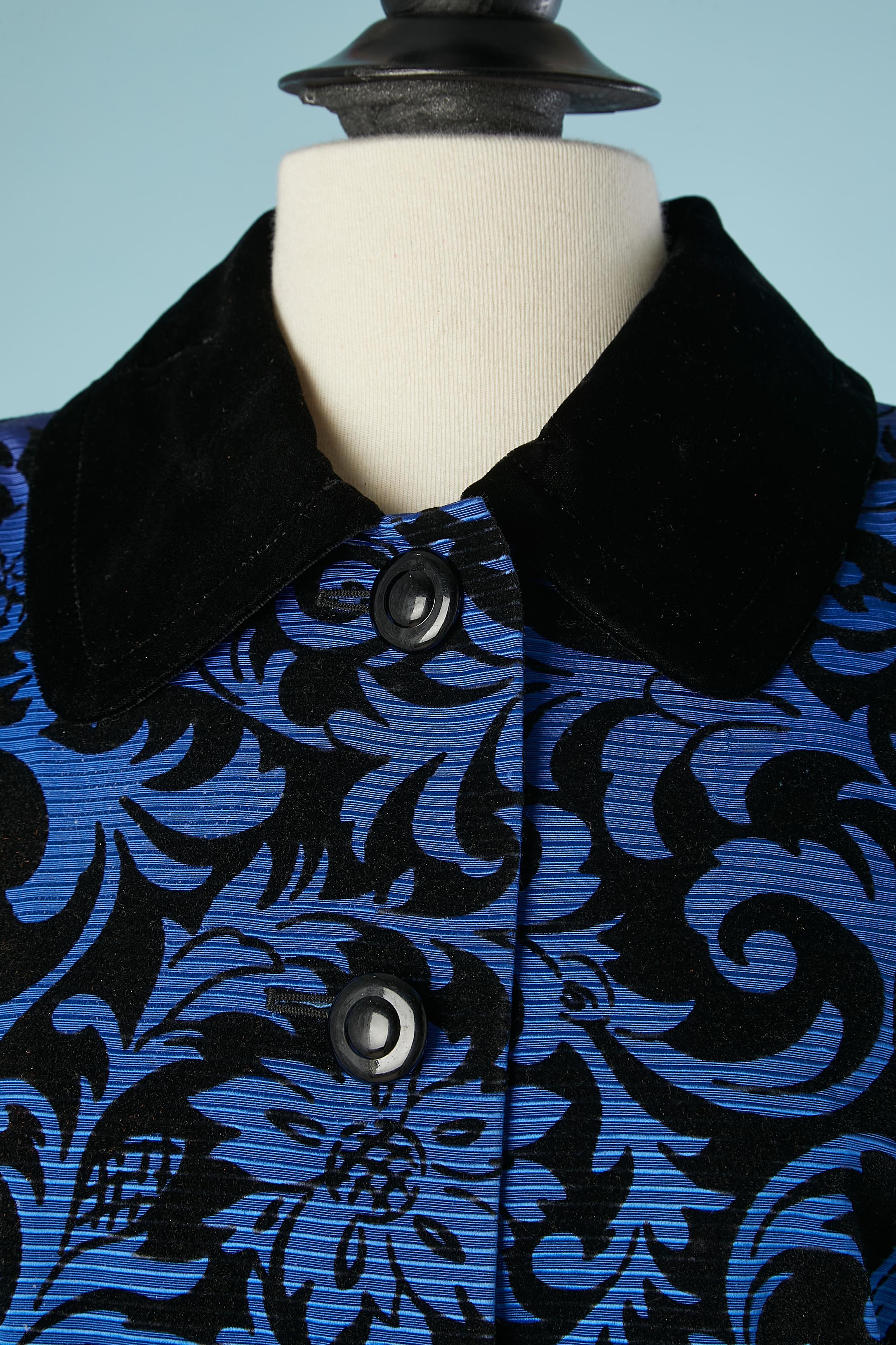 Blue Ottoman jacket with black velvet arabesque. Fabric composition: 57%. rayon, 43% cotton. Lining: 100% acetate 
One extra button provide. Shoulder pad. Black velvet cuffs. 
SIZE 40 (Fr) 10 (Us) 