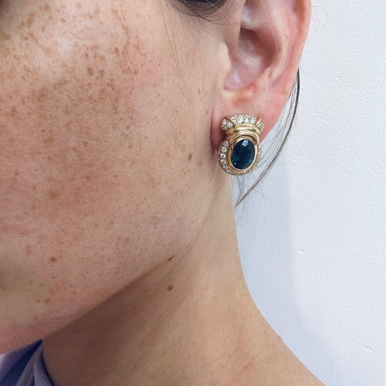 Introducing our stunning sapphire and diamond estate earrings, a true masterpiece in yellow gold. With 2 oval sapphire totaling approximately 12 ct and dazzling diamonds at 2.3 ct, these earrings are nothing short of magnificent. The deep blue hues