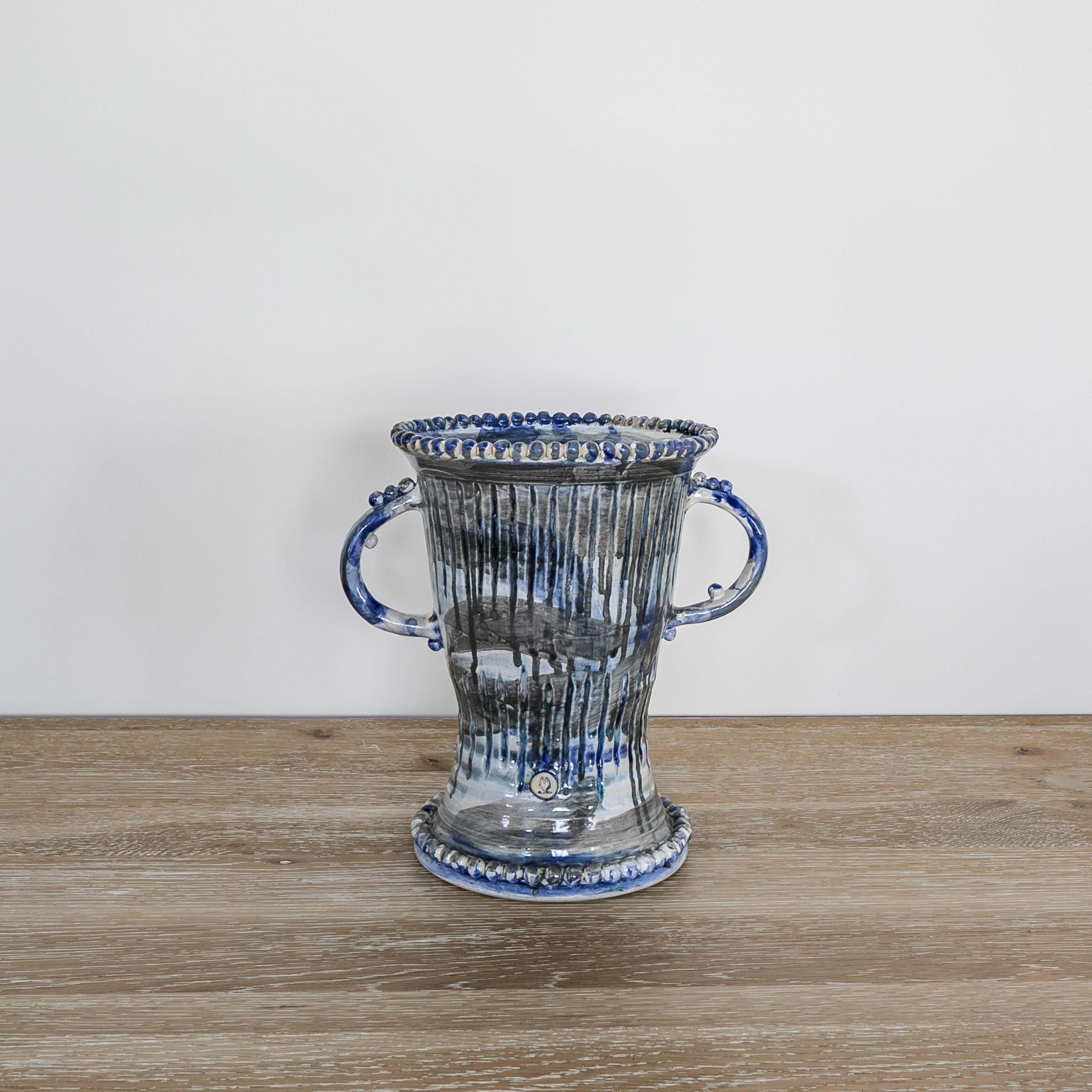 Blue Painted Ceramic Double Handle Urn handmade by artist Kimberly Mannix. The artists painterly style of drips and paint strokes of blue, grey and white give it a lyrical feel. The detailing of small balls decorating the top, bottom and the handles