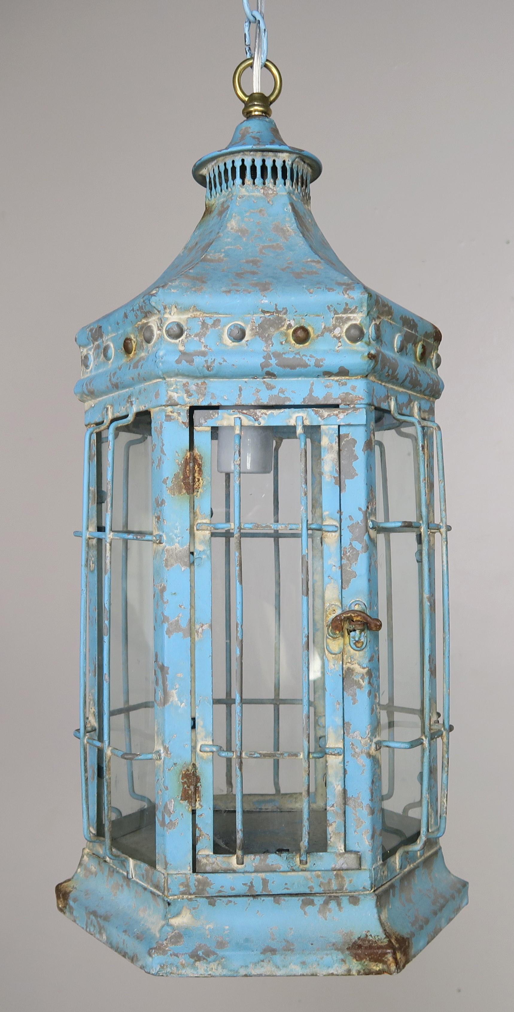 Chinoiserie style blue painted pagoda shaped lantern. This fixture still has its original antique glass. The lantern has been wired (it originally held a candle) and includes chain and canopy.