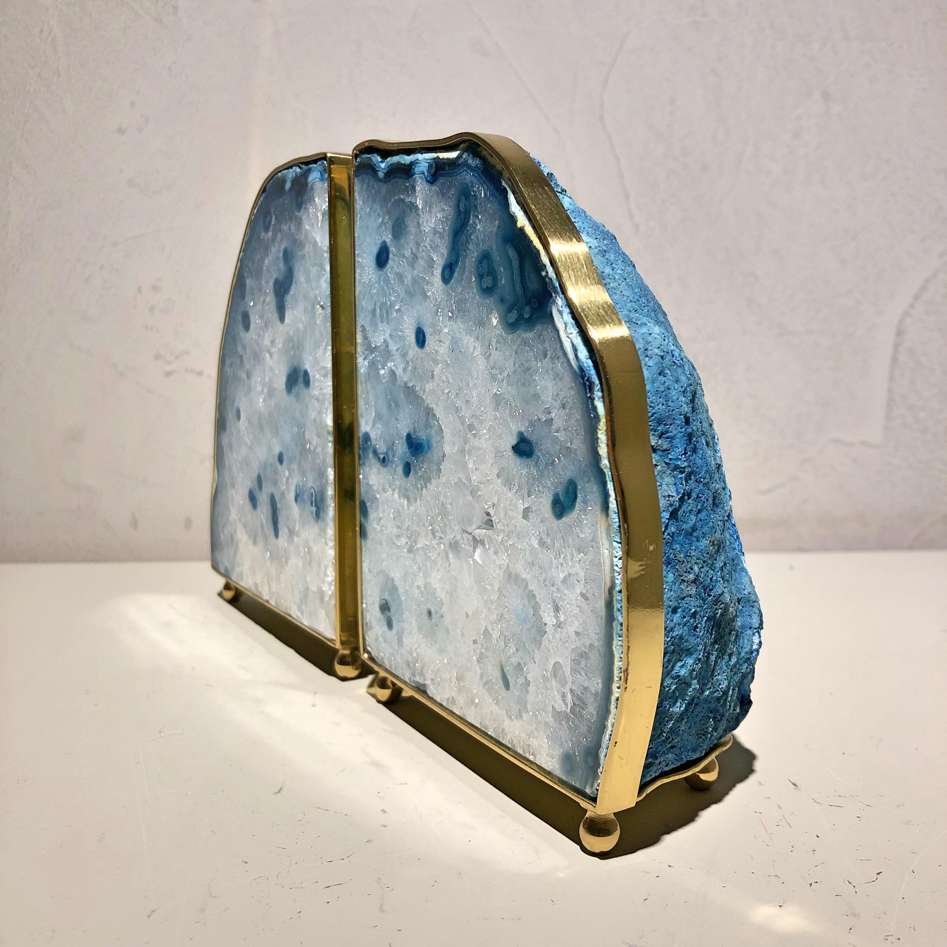 Blue agate and polished and garnished brass pair of bookends.

Natural stone integrates with the different design languages, combining straight and sinuous curves in sophisticated fluidity. The stones range from agate buds, amethyst, citrine to