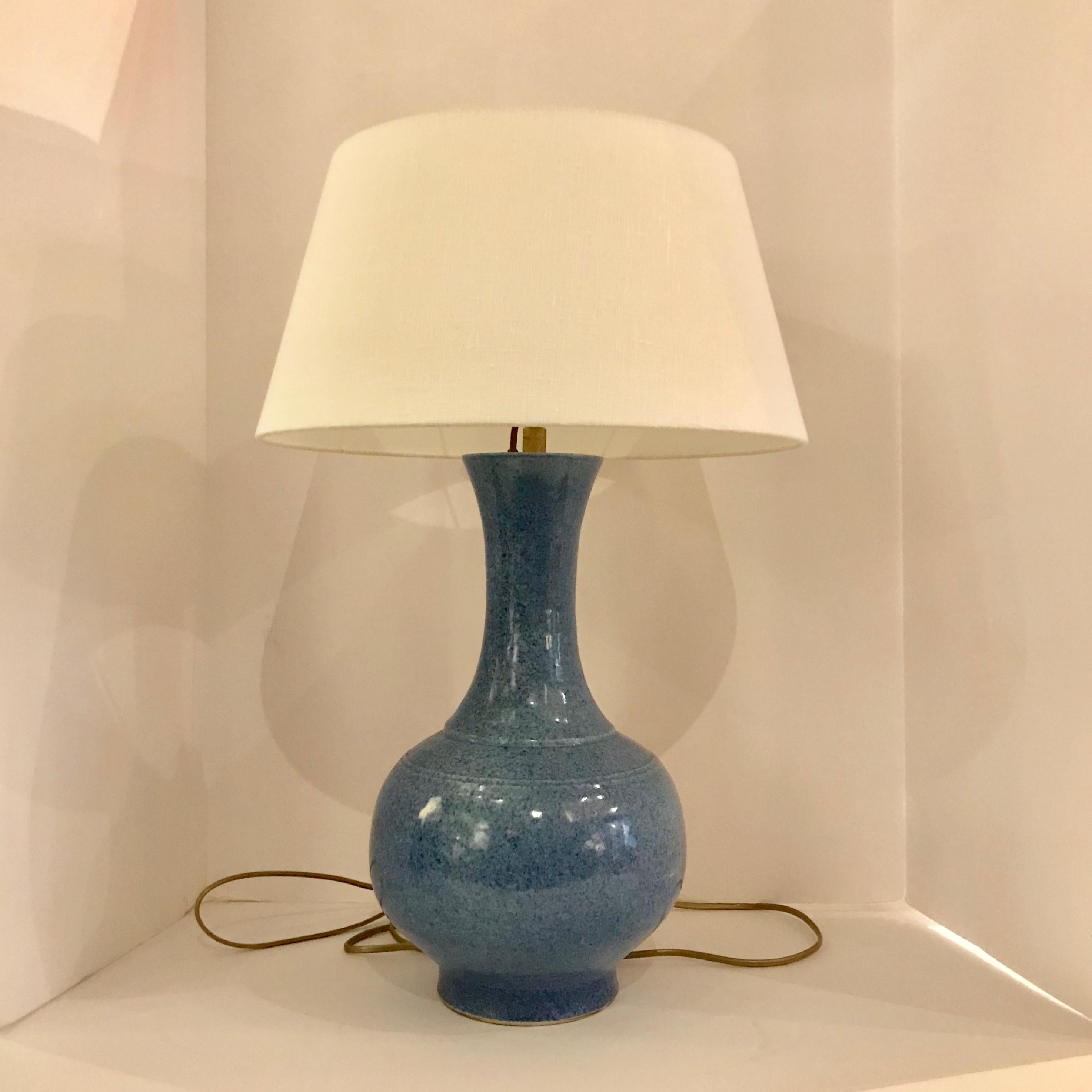 Contemporary Chinese pair mottled blue curved thin neck with round base lamps.
New Belgian linen shade.
Measures: Overall height including shade 22