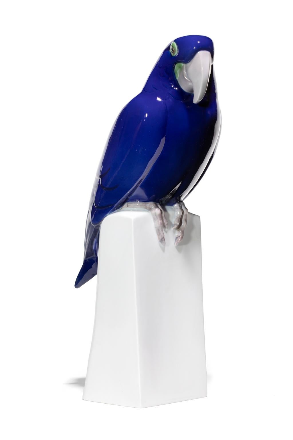 Blue Parrot on its perch appears to be the perfect companion. Its attention is perked and it looks as if it is about to begin a conversation about a cracker you may be holding. It comes across as friendly and strong and the intense blue of the glaze