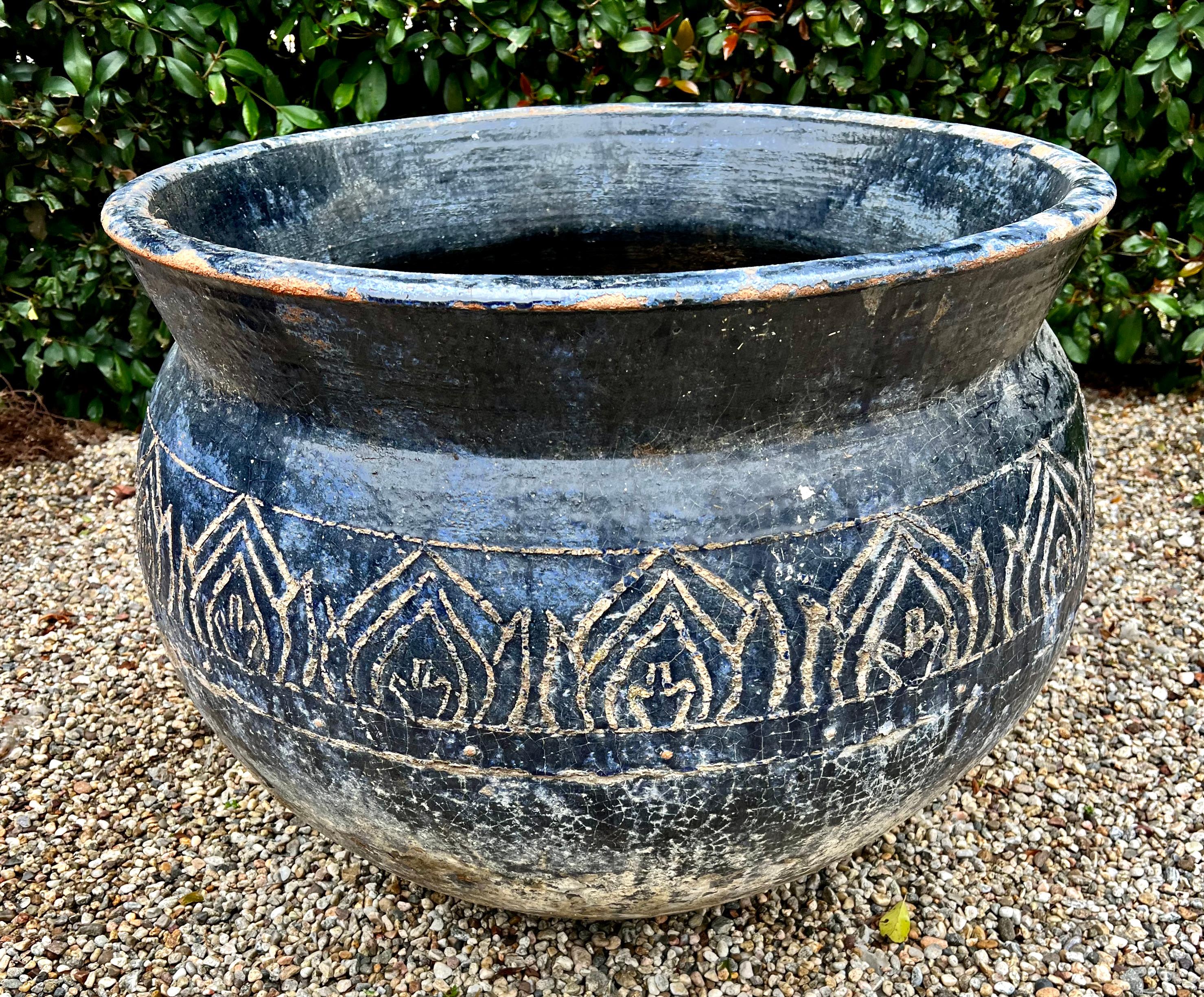 A very large terracotta Planter with patinated blue glaze and design work etched into the glaze. A perfect container for a tree or larger piece. The planter is of substantial weight and is very sturdy - 

A Compliment to many interior or exterior