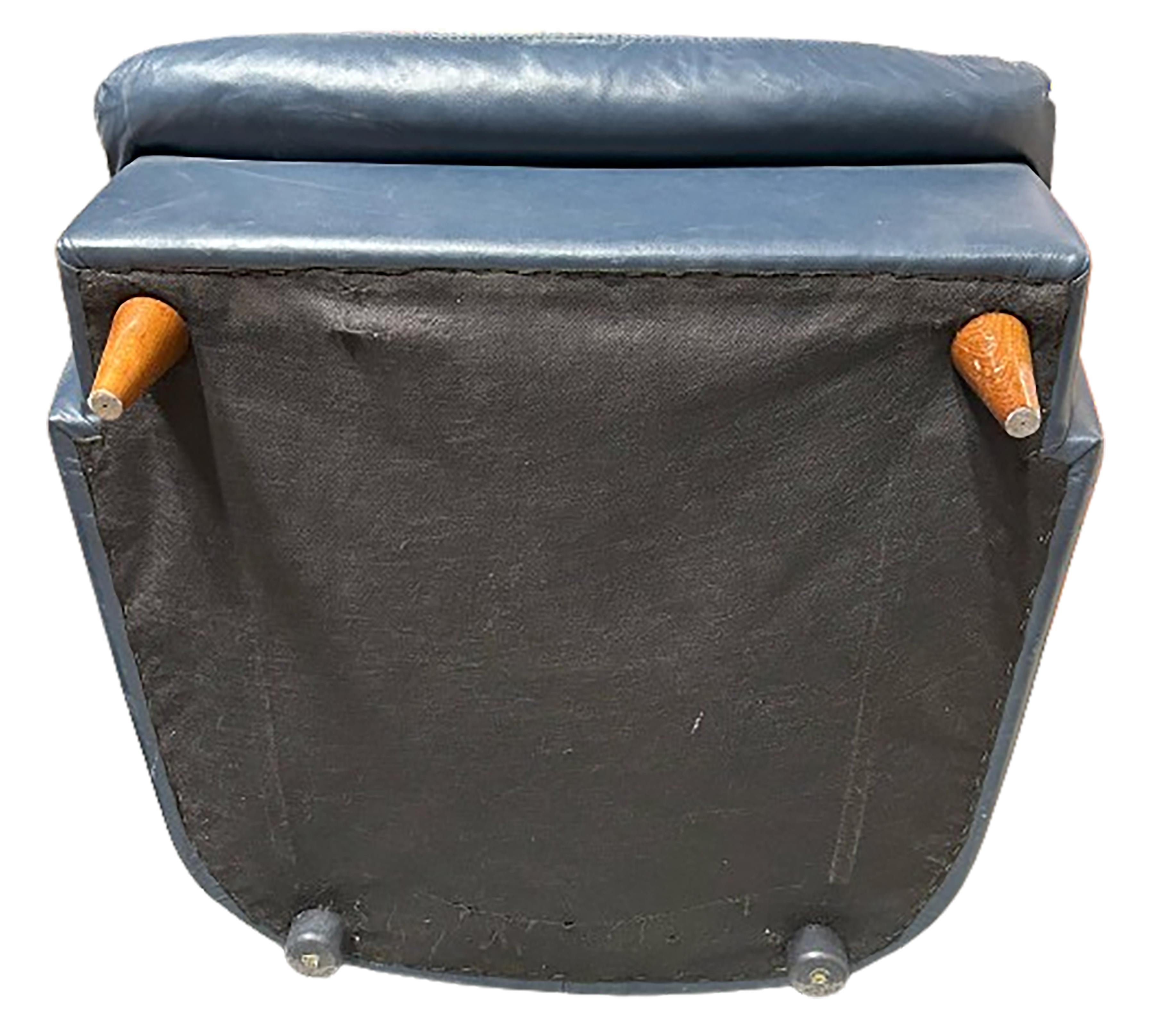 A handsome indigo blue patinated leather wing back lounge chair. 20th Century made. Small gold pillows not included.

No obvious markings on either of the pieces. 

In very good condition. Some gentle wear consistent with age and use.  

This would