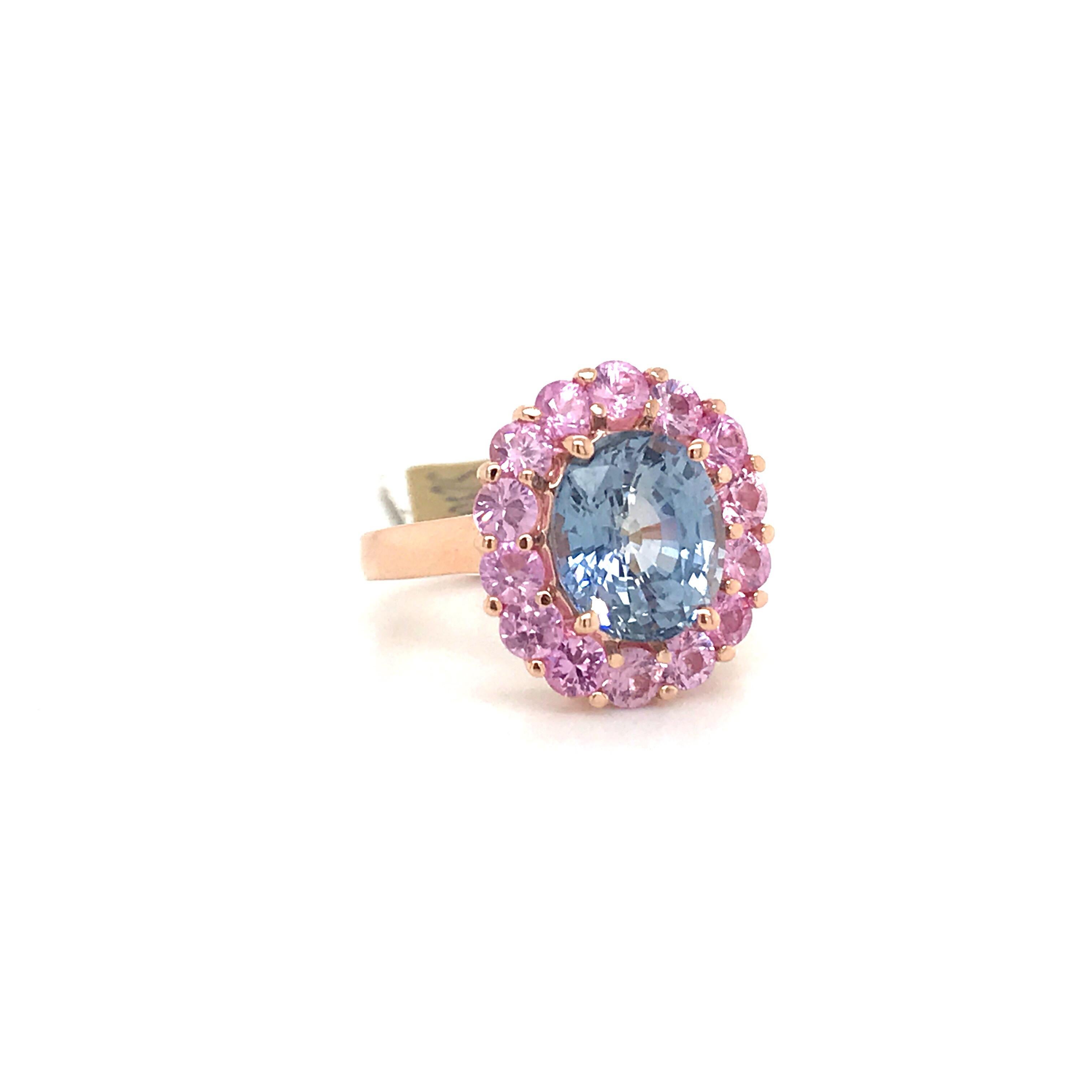 14K Yellow gold cluster cocktail ring featuring one oval cut blue sapphire weighing 4.58 carats flanked with round cut pink sapphires weighing 2.05 carats.

Ring is resizeable. 