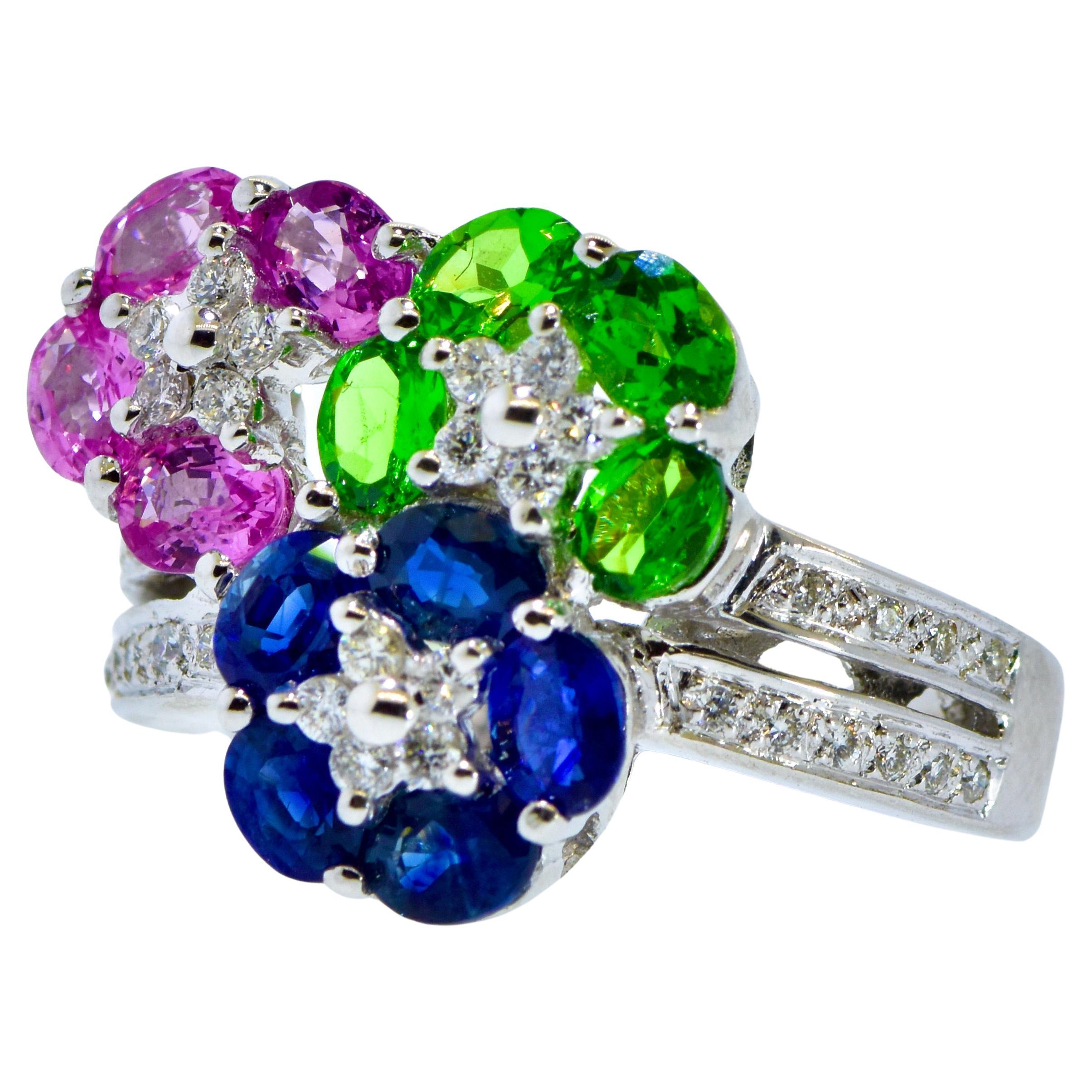 LeVian white gold ring with blue and pink Sapphires, and bright green Tsavorites with white brilliant cut diamonds all create a very fine contemporary ring by the famous firm of LeVian.  The  fine bright and clean oval cut sapphires (both pink and