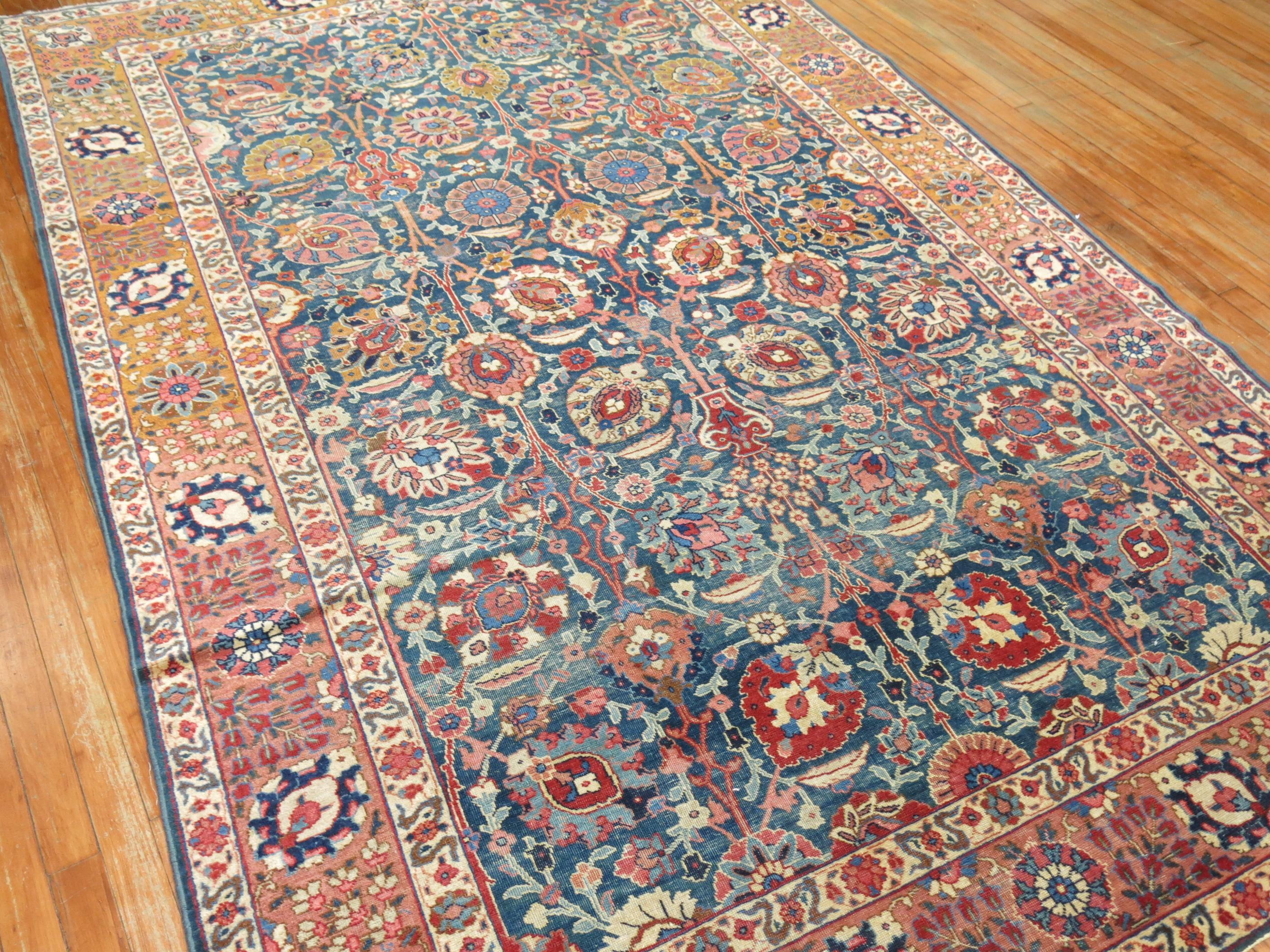 Classic all-over design Persian Tabriz rug with a green blue ground, pink dominant accents and brown border, circa 1940.

Measures: 6' x 9'3