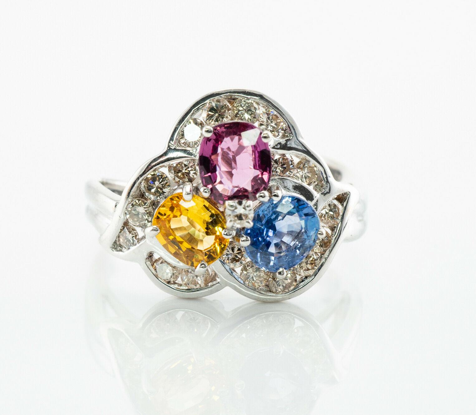 This gorgeous estate ring is finely crafted in solid 14K White Gold and set with genuine Earth mined Sapphires: blue, pink, and yellow gems. Each oval cut stone measures 5mm x 4mm totaling 1.35 carats. These amazing gems are so clean, clear, and