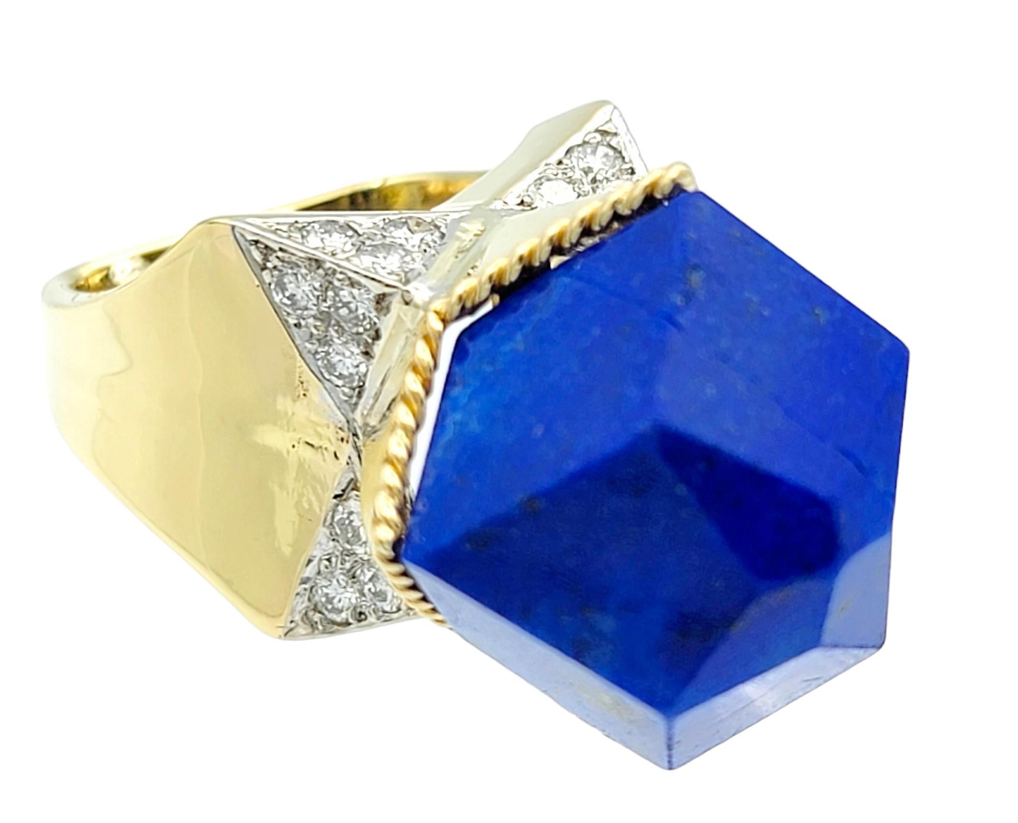 Ring comfortably fits on a size 5.5 but has sizing beads for adjustment.

This incredible lapis lazuli and 18 karat yellow gold ring is a captivating statement piece fit for any special occasion. At its heart lies a resplendent 21-sided polygon,
