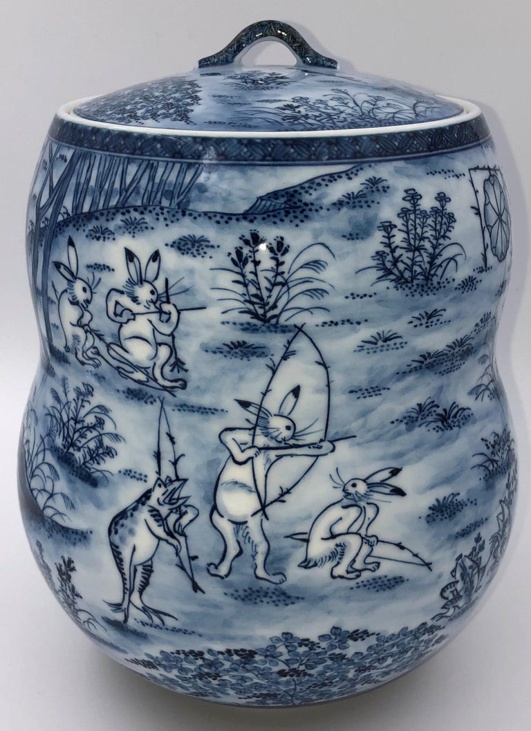 Extraordinary Tea ceremony mizusashi (lidded jar,) stunningly intricately hand painted in underglaze blue, to recreate parts of Choju Giga, or ‘Frolicking Animals’ which is designated as a Japanese National Treasure. Choju Giga is a set of four