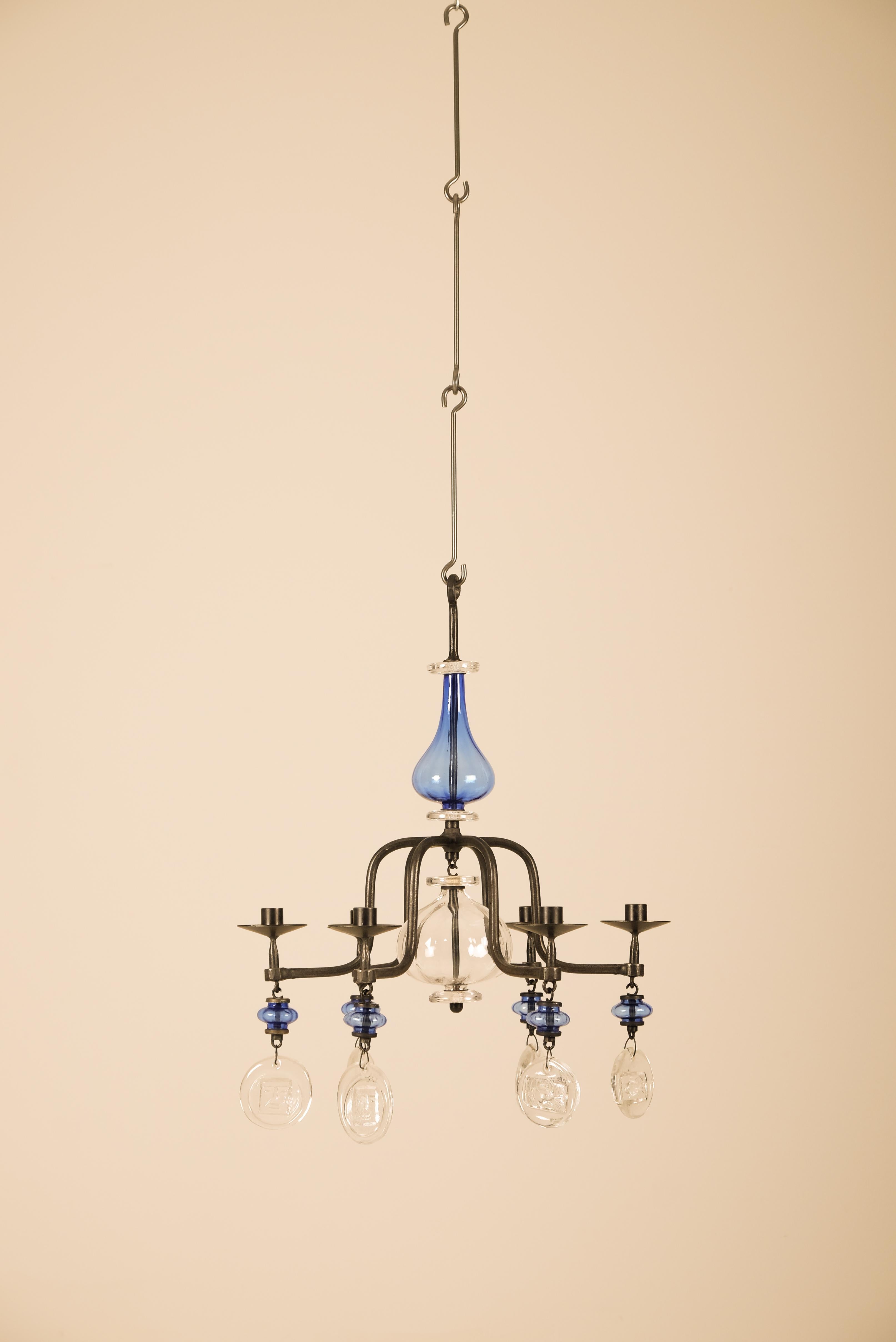 Lustre vintage d'Erik Höglund, produit en Suède dans les années 1960.
Pendentifs en fer forgé doré et en verre moulé avec différentes figures.
 