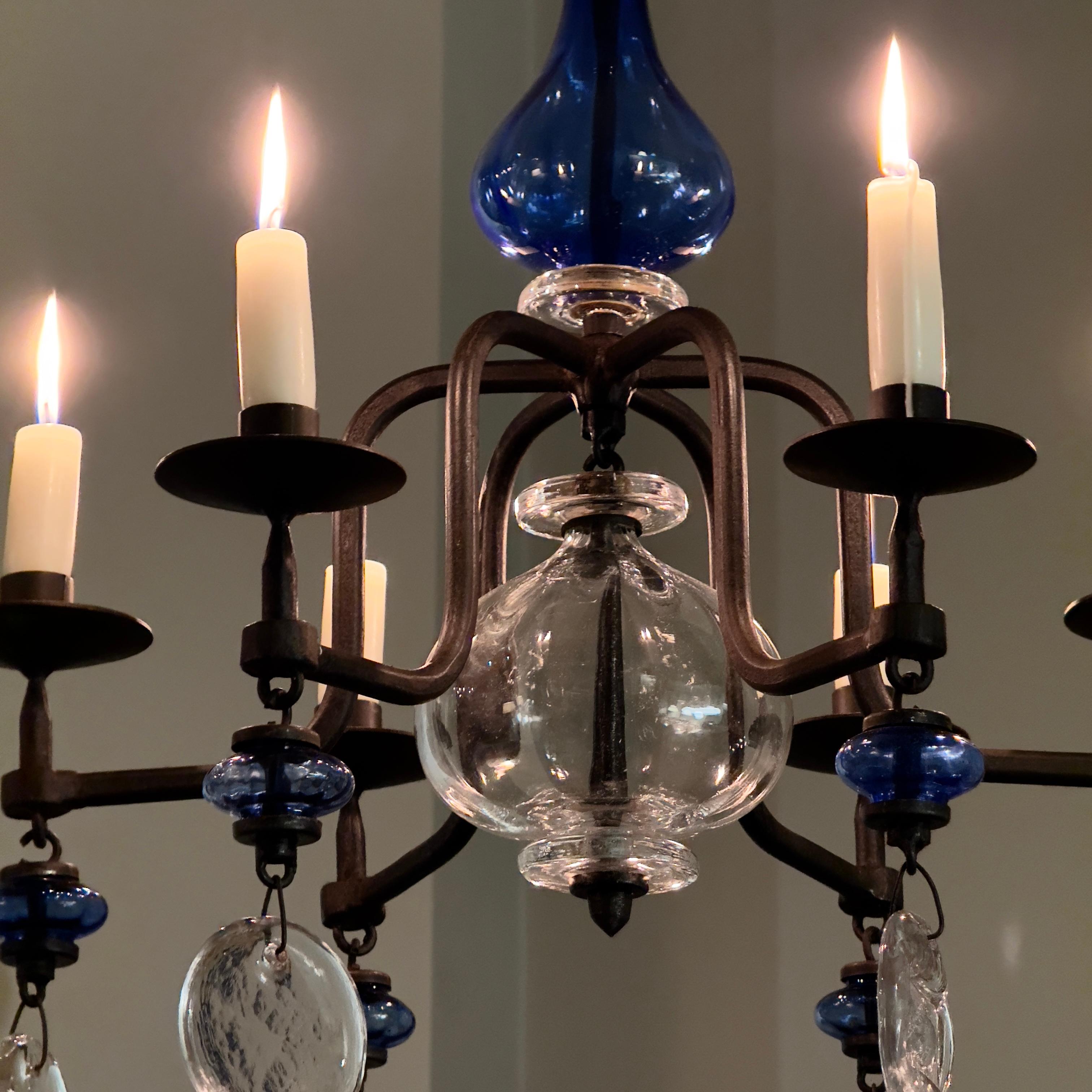 Description:
A wrought-iron and pressed-glass chandelier designed by Erik Höglund for Kosta Boda during the 1960s. The blackened wrought-iron framework of this 6-armed chandelier is adorned with a frothy constellation of pressed glass circles.