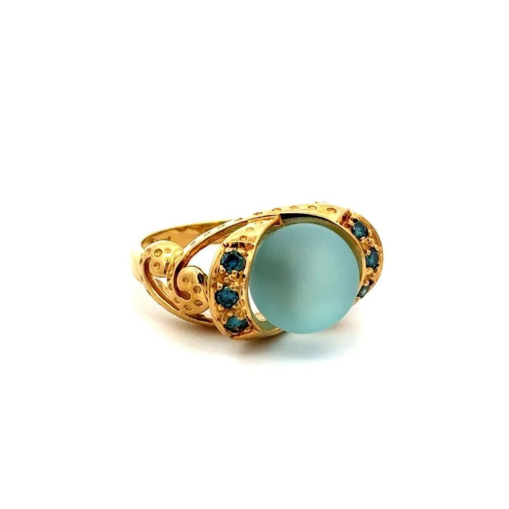 Simply Beautiful! Blue Quartz Ball and Irradiated Blue Diamond Gold Solitaire Ring. Centering a securely nestled Hand set Blue Quartz Ball. Accented on either side by Irradiated Blue Diamonds, weighing approx. 0.12tcw. Beautifully Hand crafted 14K