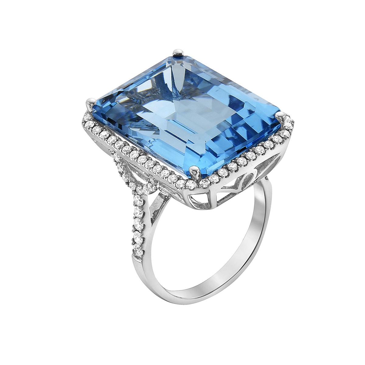 With this exquisite semi-precious blue quartz ring, style and glamour are in the spotlight. This 14-karat emerald cut ring is made from 6.1 grams of gold, 1 blue quartz totaling 27.37 karats, and is surrounded by 76 round SI1-SI2, GH color diamonds