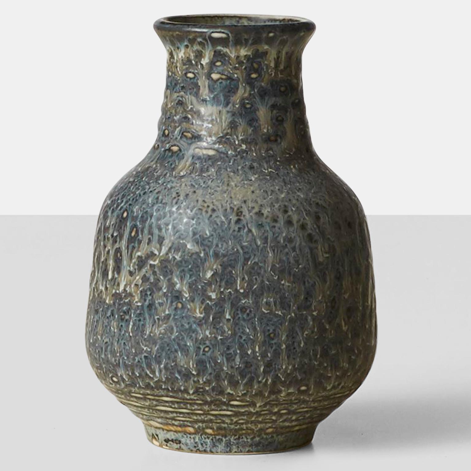 A mottled blue vase by Gunnar Nylund for Rorstrand. Elegant vase with a small stature. Inscribed on the bottom with the makers and the manufacturer's mark. 
