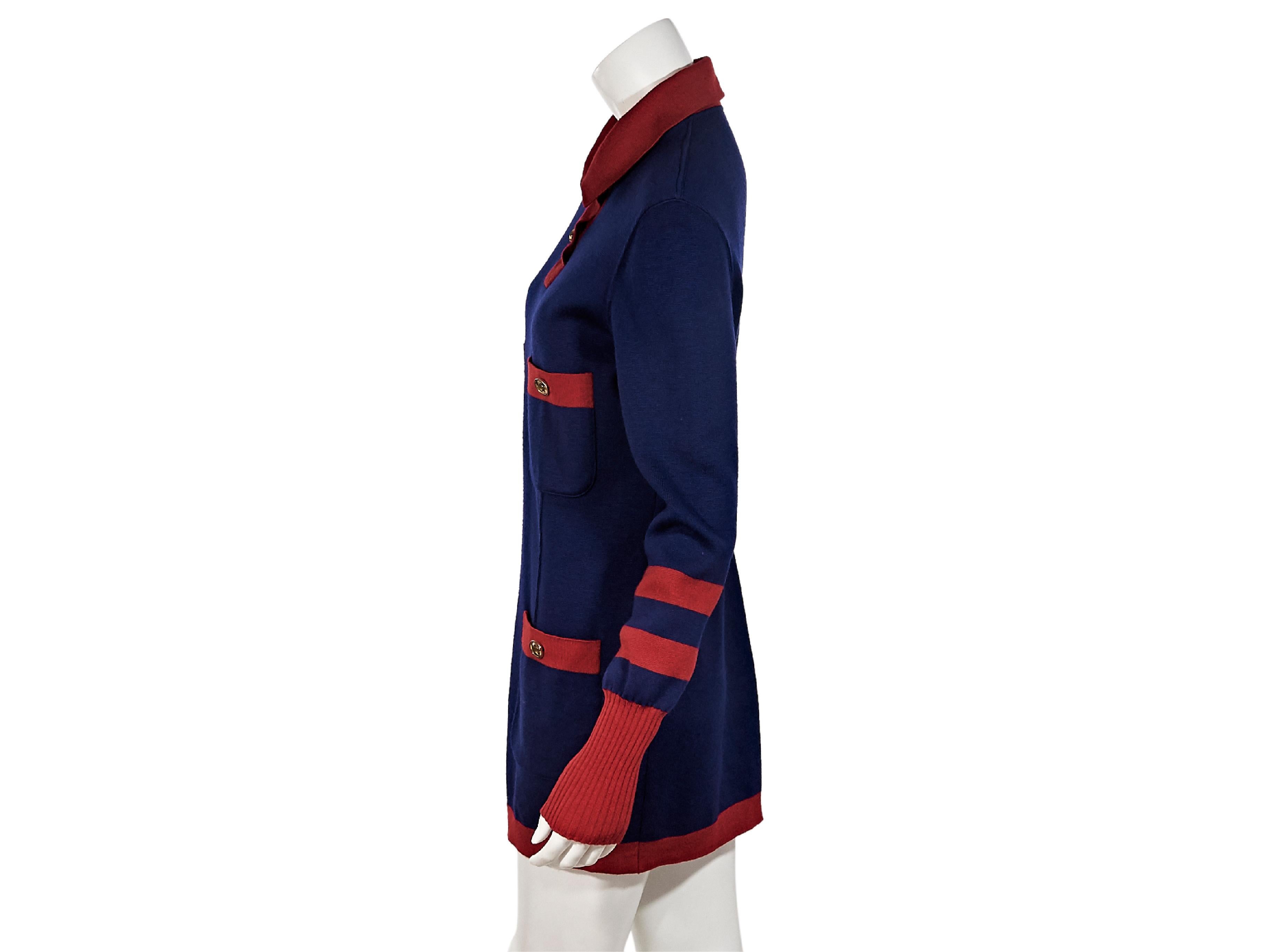 Product details:  Blue and red knit sweater dress by Chanel.  Point collar.  Two-button placket.  Long sleeves.  Ribbed cuffs.  Chest and waist button patch pockets.  Pullover style.  Goldtone hardware.  38