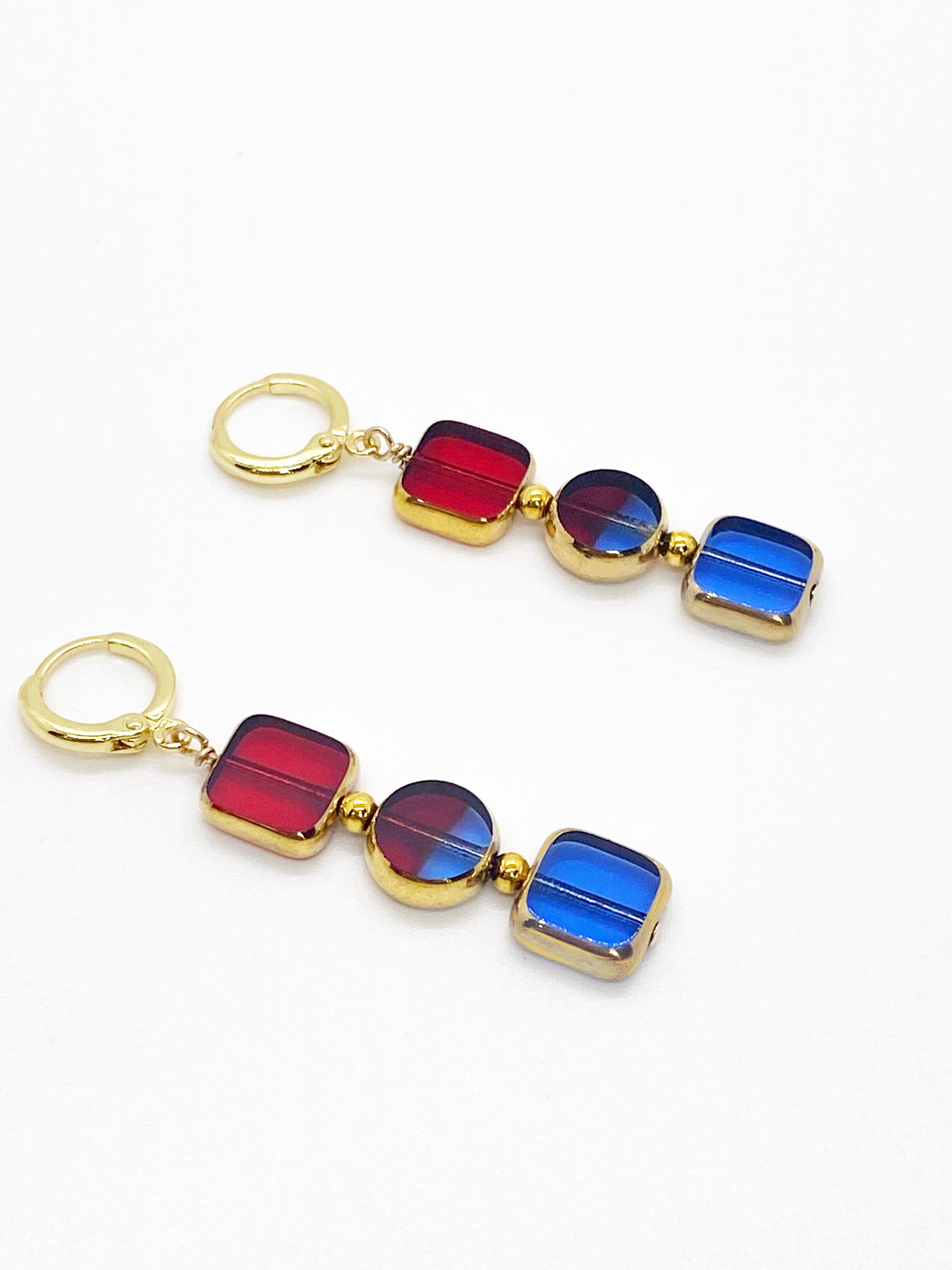 Each earring is composed of 3 vintage translucent glass beads. The glass beads are framed with 24K gold and were handmade in Germany between the 1920s - 1960s. They are now considered rare and collectible. The beads dangle on 24K gold-filled earring