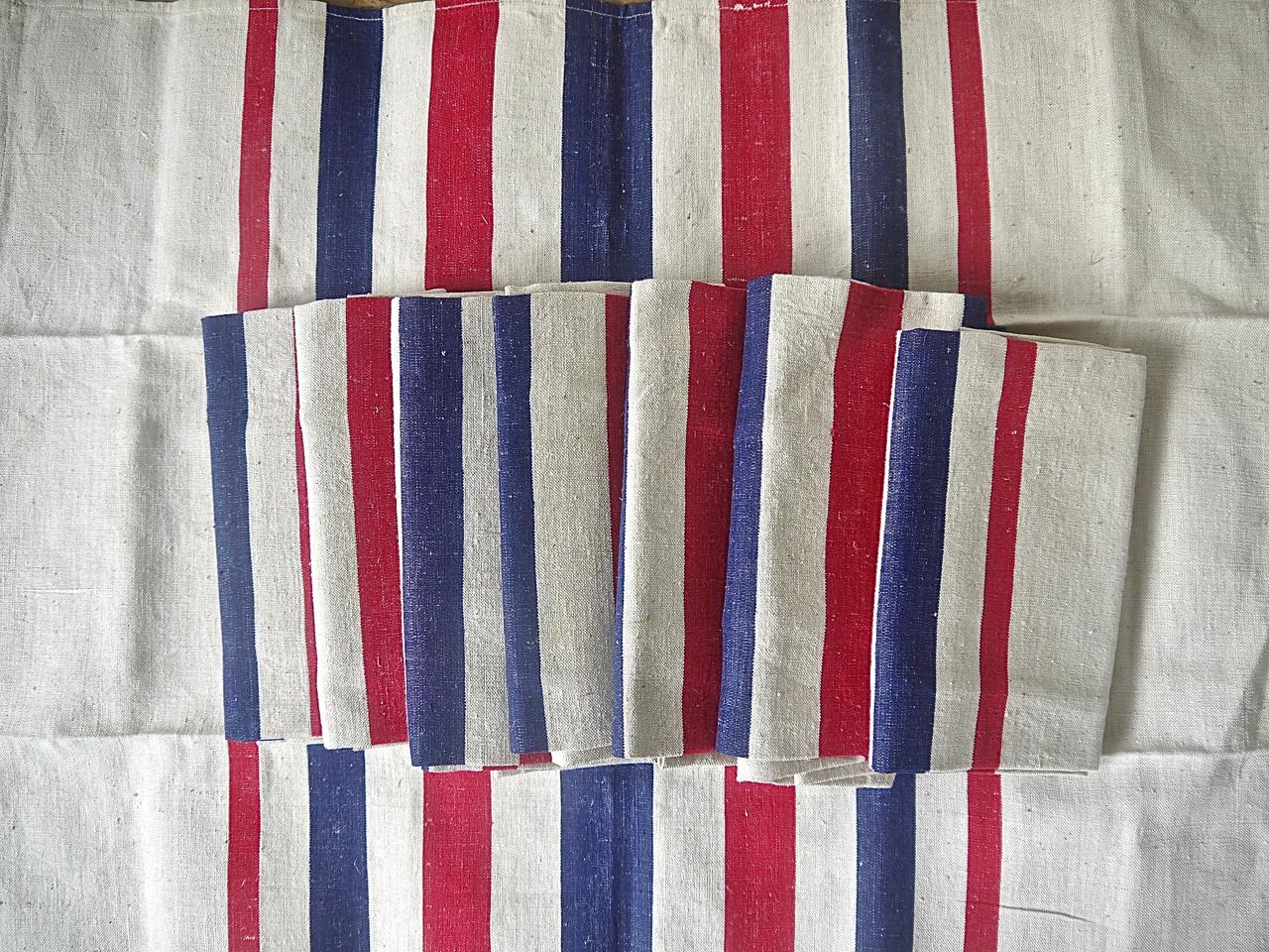 Set of eight early 20th century French Basque blue, red and white striped napkins in a cotton and linen mix fabric. With a bold and striking design they are in an unused condition.