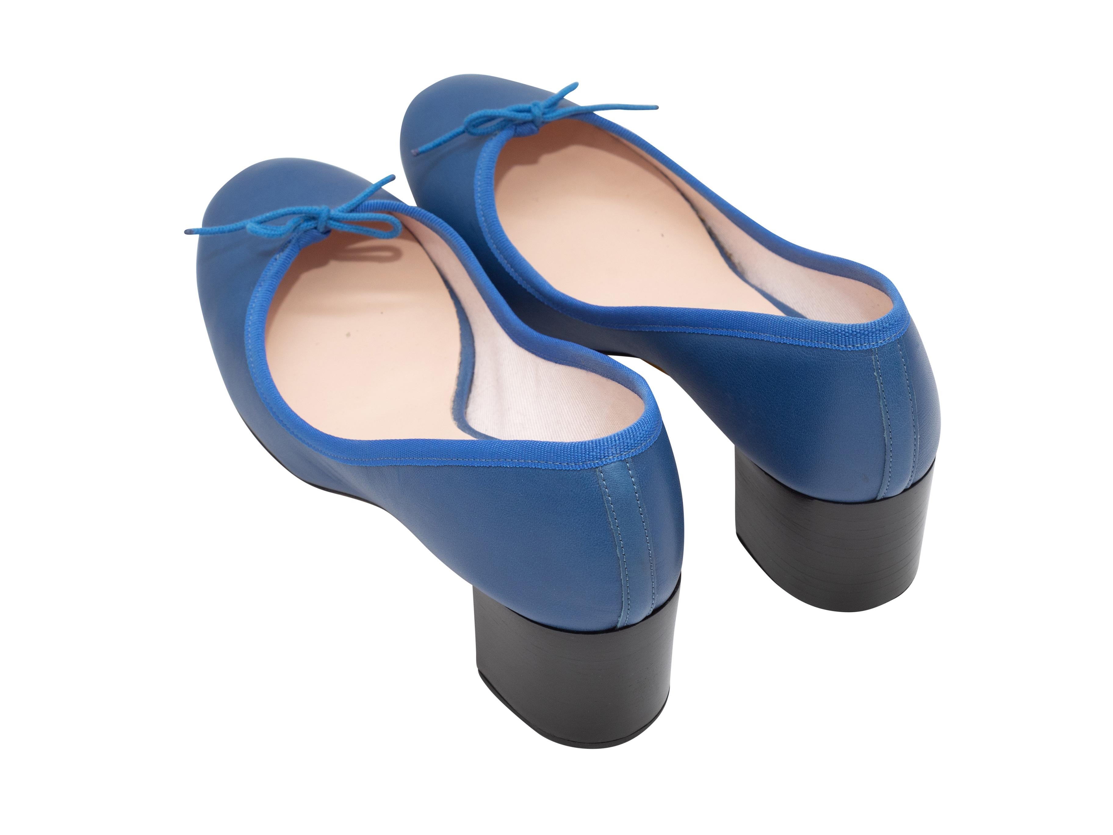 Product Details: Blue leather ballet pumps by Repetto. Bow accents at toes. Stacked block heels. 2