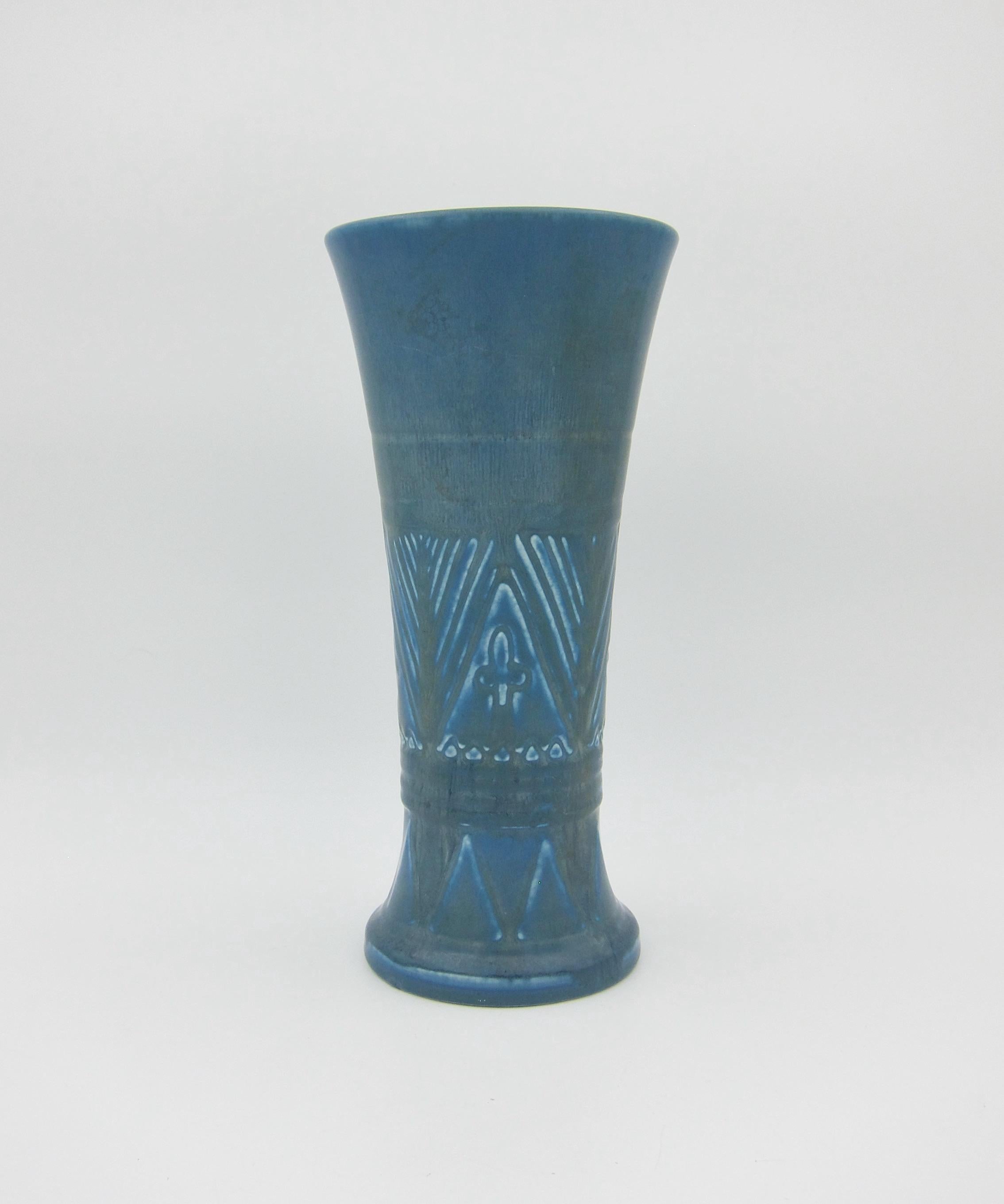 A blue Art Deco vase from Rookwood Pottery of Cincinnati, Ohio date marked for 1926. The American art pottery vessel is a substantial production piece with geometric Art Deco designs and a velvety mottled matte blue glaze with accents of olive