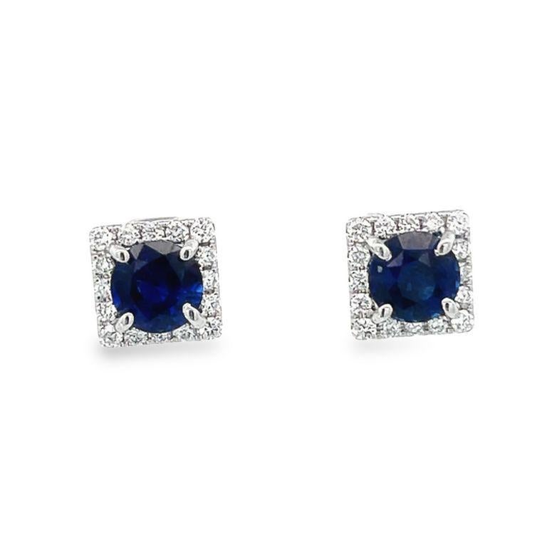 This pair of earrings are made of two round blue sapphire stones in the center with a total weight of 2.25CT carats selected for their color and beauty. These elegant blue sapphire earrings are made also with a single row of round white diamonds