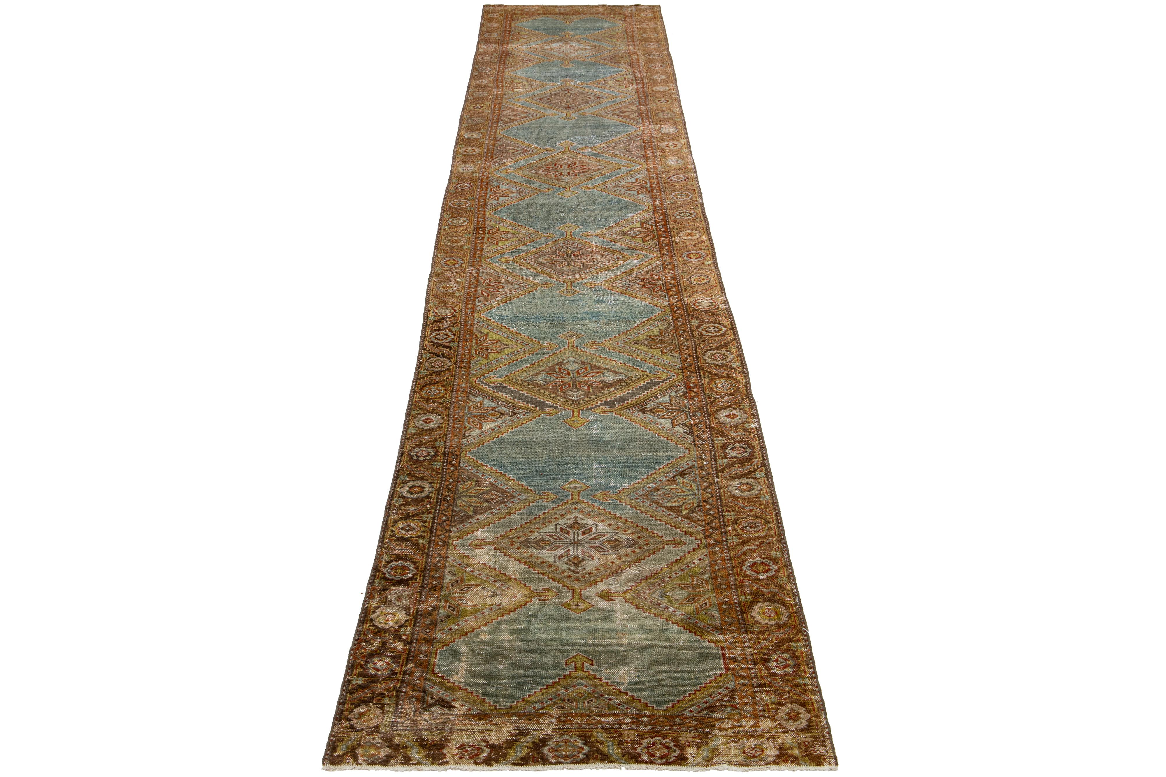 The Persian Malayer wool rug exudes an antique elegance with its hand-knotted wool construction. Its blue field is beautifully decorated with a tribal pattern highlighted by rust accents.

This rug measures 3'2