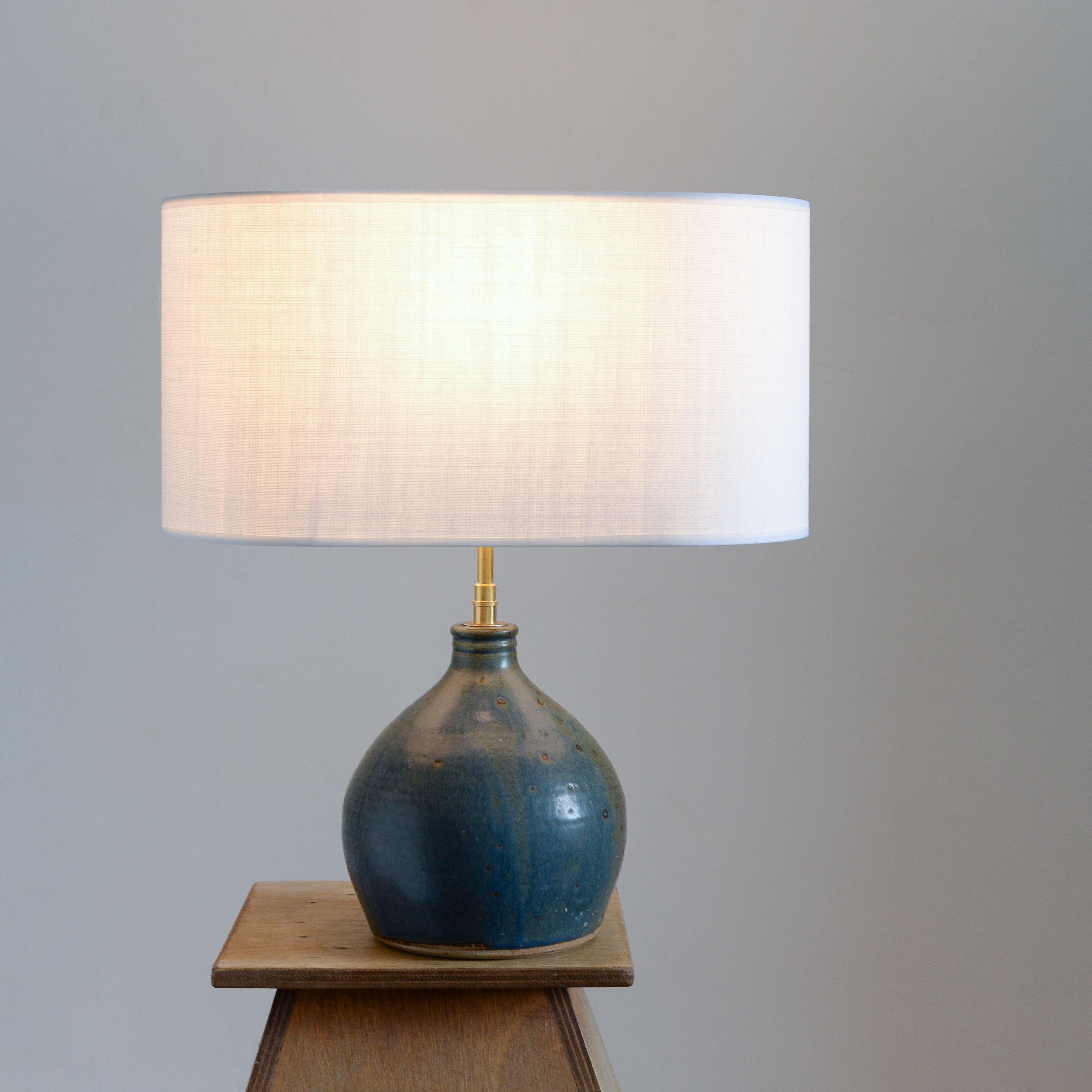Blue Sandstone Table Lamp Mid-Century Modern

This lamp base from the 1960s is a French artisanal work made of sandstone. Its surface is covered in a blue pyrite enamel, creating a unique effect of small spots of various sizes. This special enamel