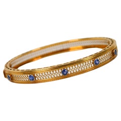 Filgree-Armreif aus 14 Karat Gelbgold mit blauem Saphir