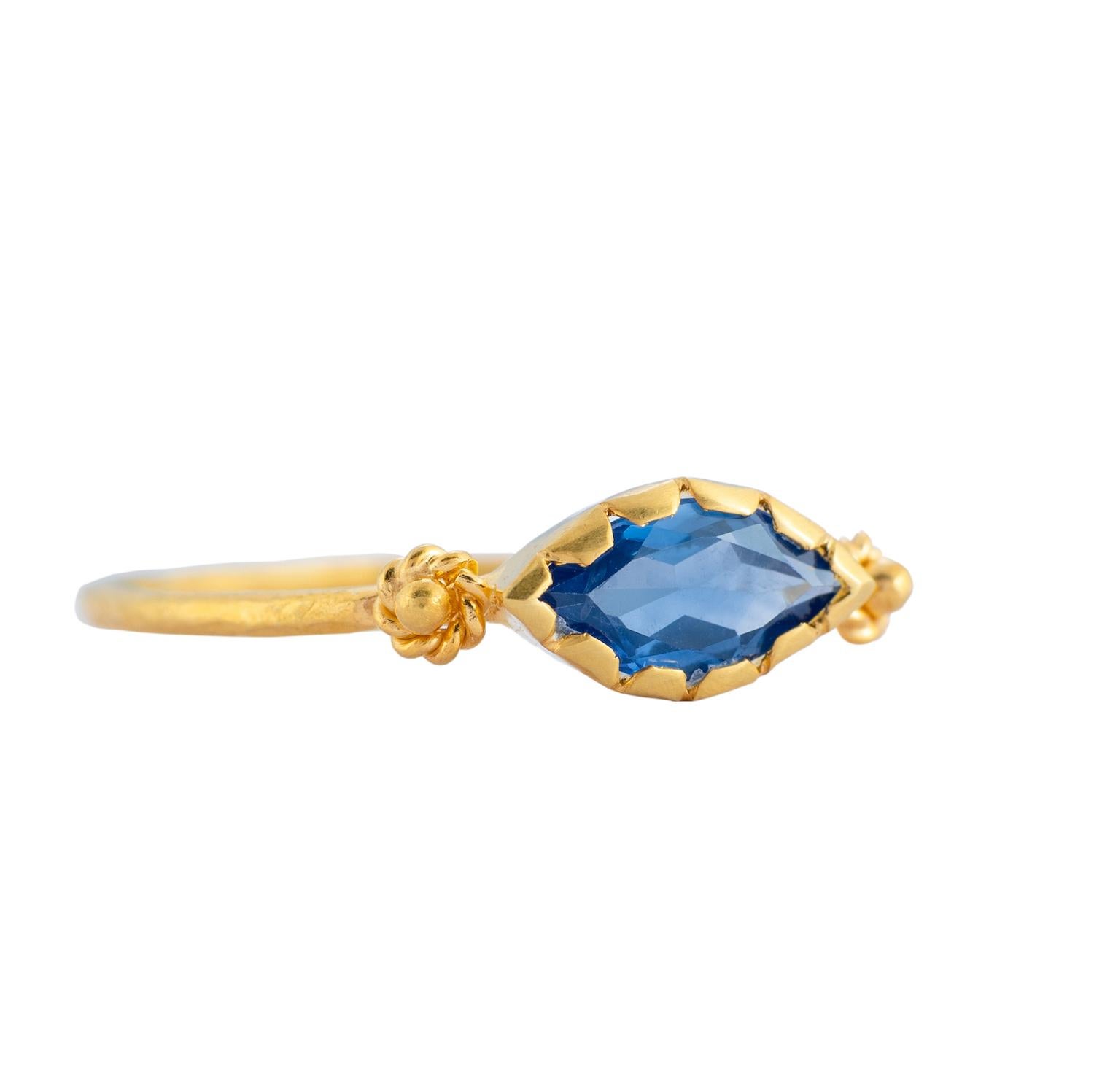 This beautiful one-of-a-kind 14ct blue sapphire gold stacking ring has been handmade in our workshops. The ring is flanked with embossed work. It looks great on it's own or stacked, whatever your preference.

Ring dimensions - 1mm
Stone size - 9mm x