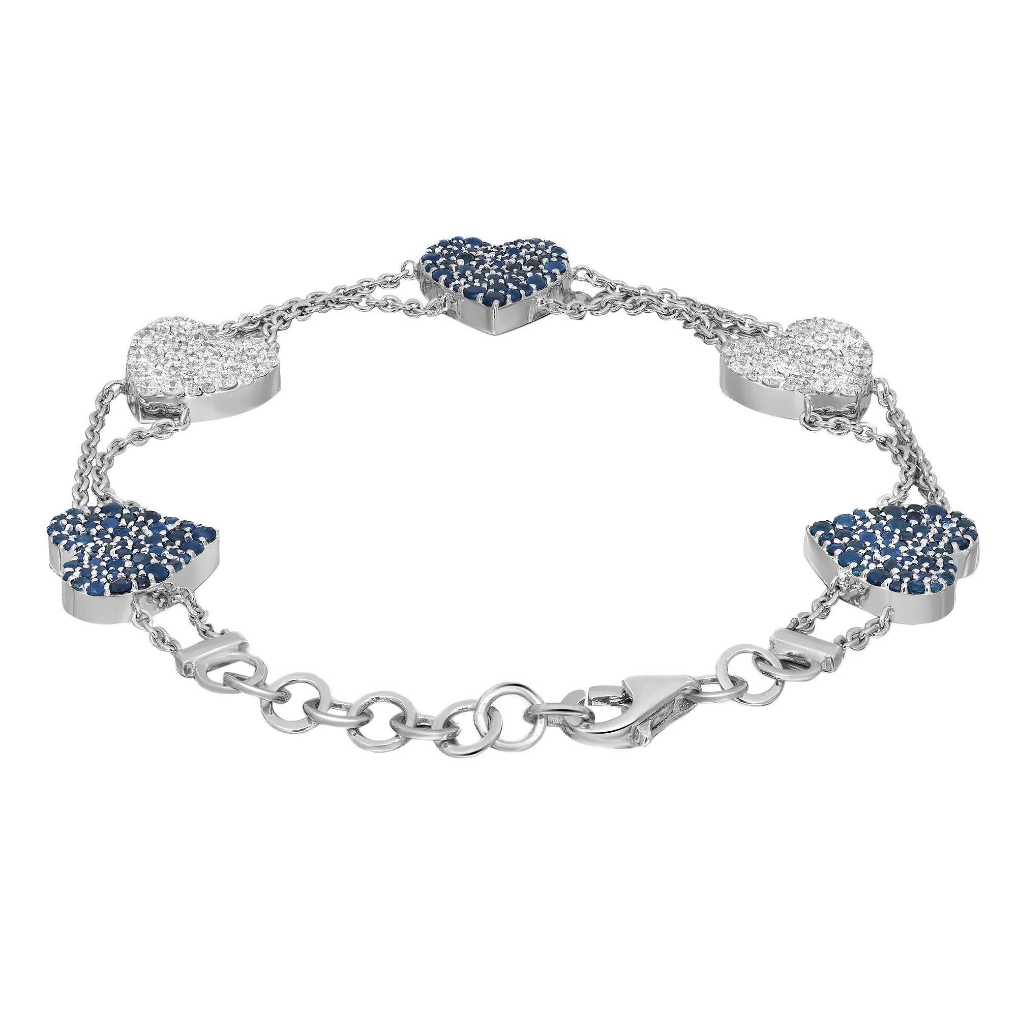 This stunning five hearts motif bracelet is a perfect valentine's gift for your loved one. Crafted in 14k white gold, it features two hearts pave set with round cut diamonds and three hearts pave set with round cut blue sapphires attached to a cuban