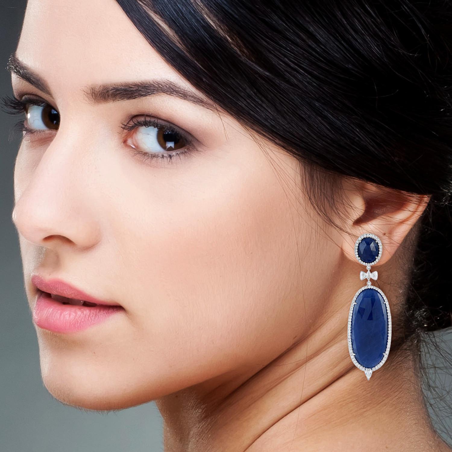 Cast in 18-karat gold, these stunning drop earrings are set with 59.34 carats blue sapphire and 2.04 carats of sparkling diamonds. 

FOLLOW  MEGHNA JEWELS storefront to view the latest collection & exclusive pieces.  Meghna Jewels is proudly rated