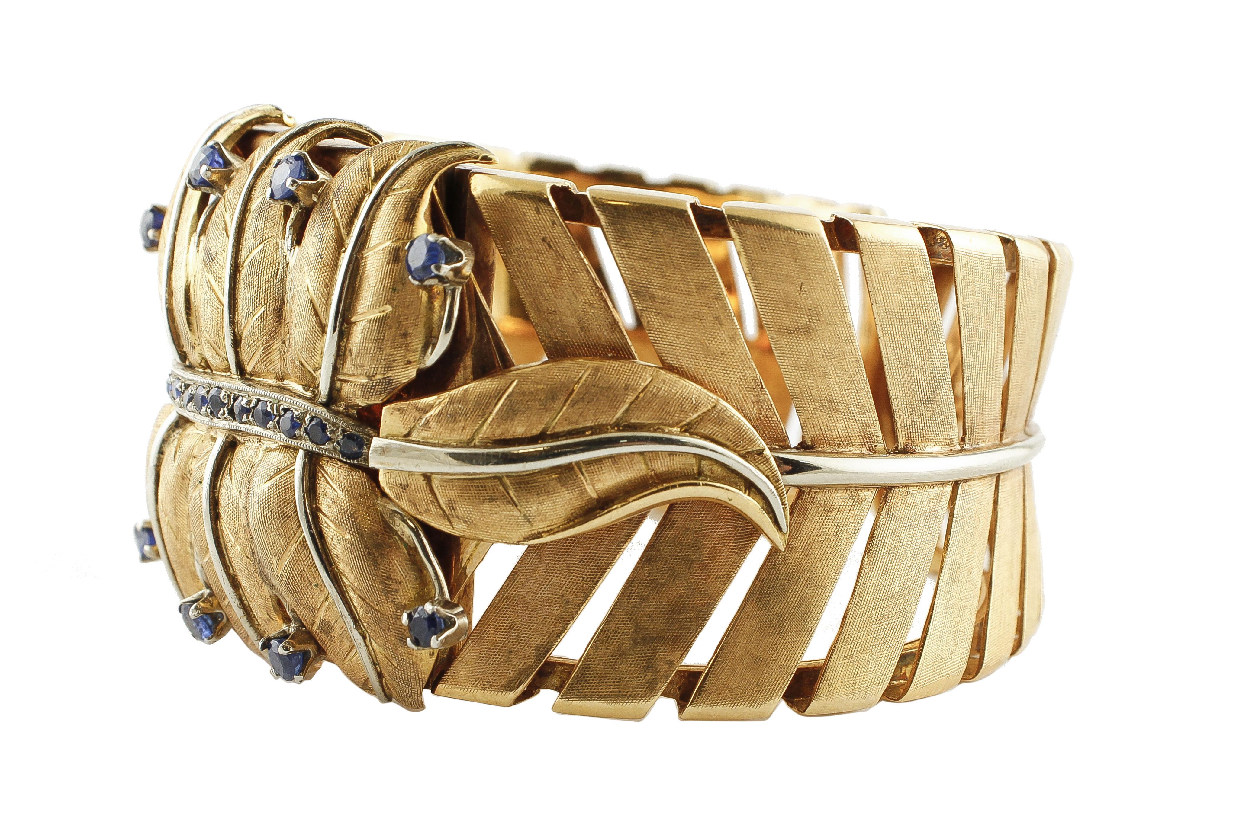 Astonishing retro cuff bracelet in 18k rose gold and white gold structure. The bracelet is designed with leaves motif with a central leaves theme studded with beautiful blue sapphires. 
This fantastic bracelet is totally handmade by Italian master