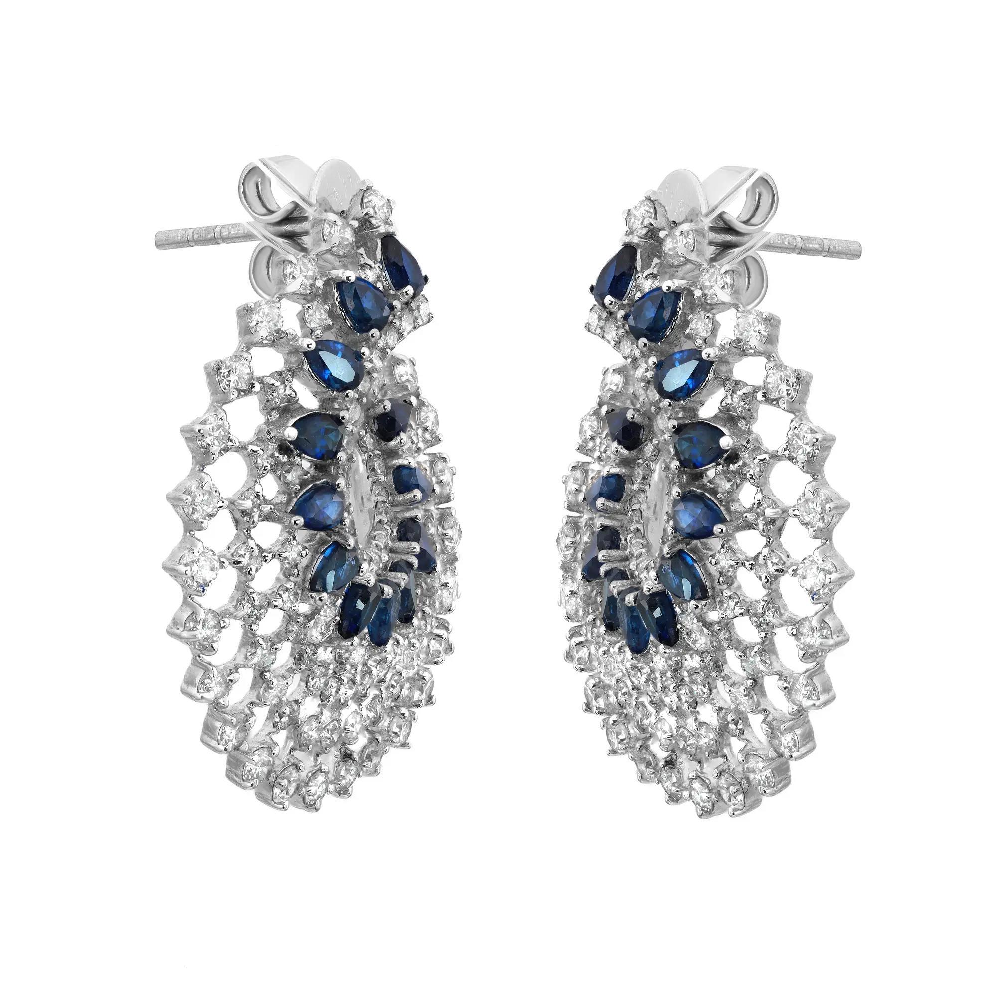 Elevate your attire with these dazzling hoop earrings. Crafted in fine 14K white gold. These earrings feature prong set pear shape blue sapphires weighing 2.07 carats with round cut diamonds weighing 2.45 carats. Diamond quality: color H-I and