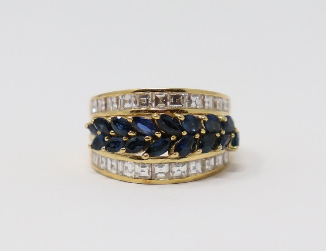 18 Karat yellow gold ring with central 2.50 Carat navette cut blue sapphire. The sapphire is surrounded by carrè cut diamonds total about 2 Carat. 
Total weight:  12.70 g.
New contemporary jewelry. Produced in the famous Italian city of gold