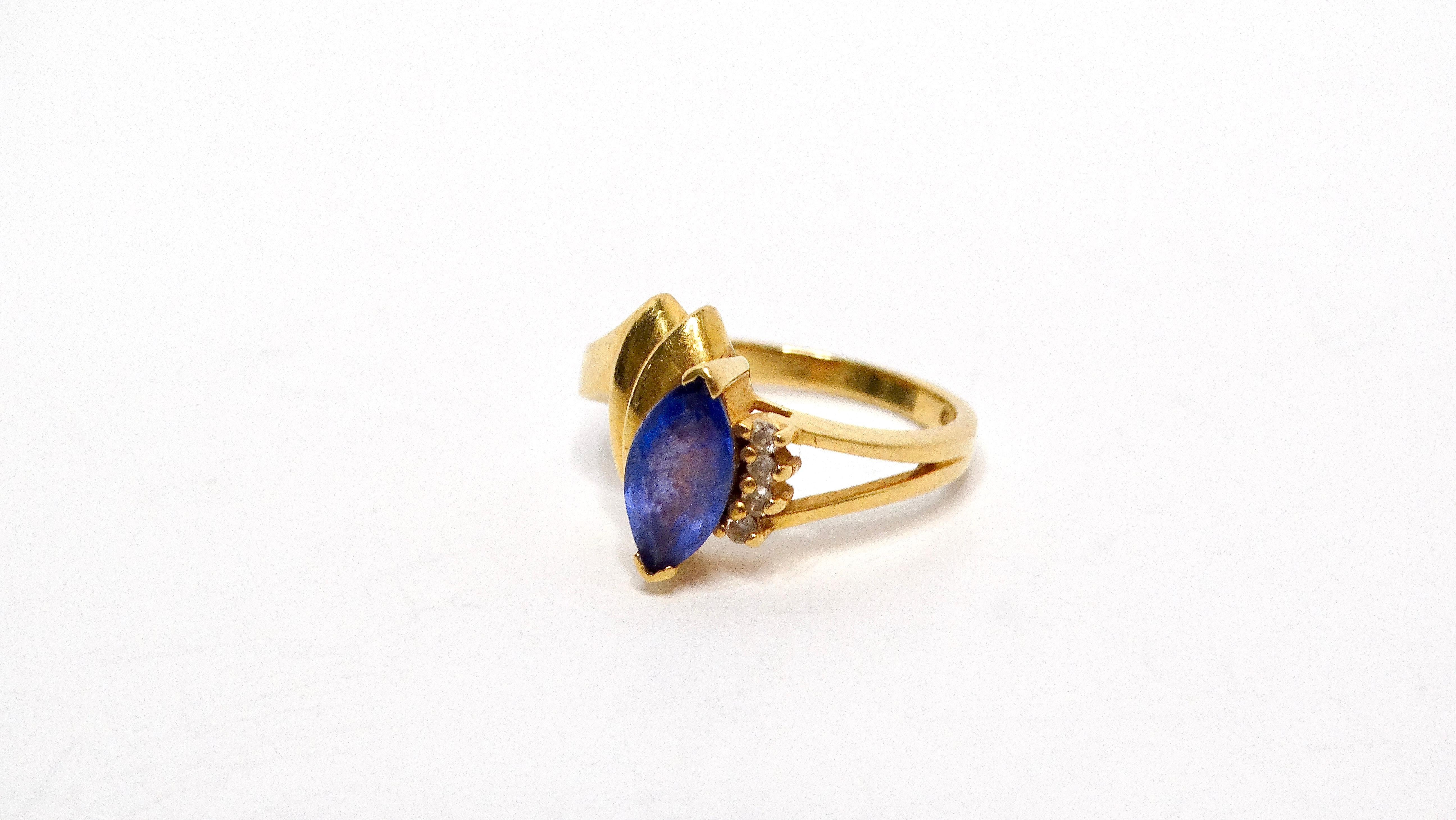 The Blue Sapphire & 4 Diamond Vintage 14k Gold Ring is a timeless piece that exudes elegance and sophistication, making it a perfect addition to any jewelry collection. This exquisite ring showcases a stunning blue sapphire at its center, which is