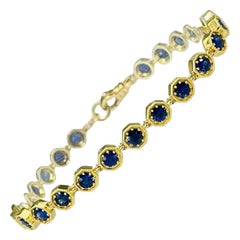 Bracciale tennis in zaffiro blu e oro giallo 18 carati, 4,96 carati totali, 7 pollici