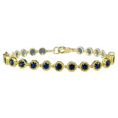 Tennisarmband aus 18 Karat Gelbgold mit blauem Saphir und 4,96 Karat insgesamt, 7 Zoll