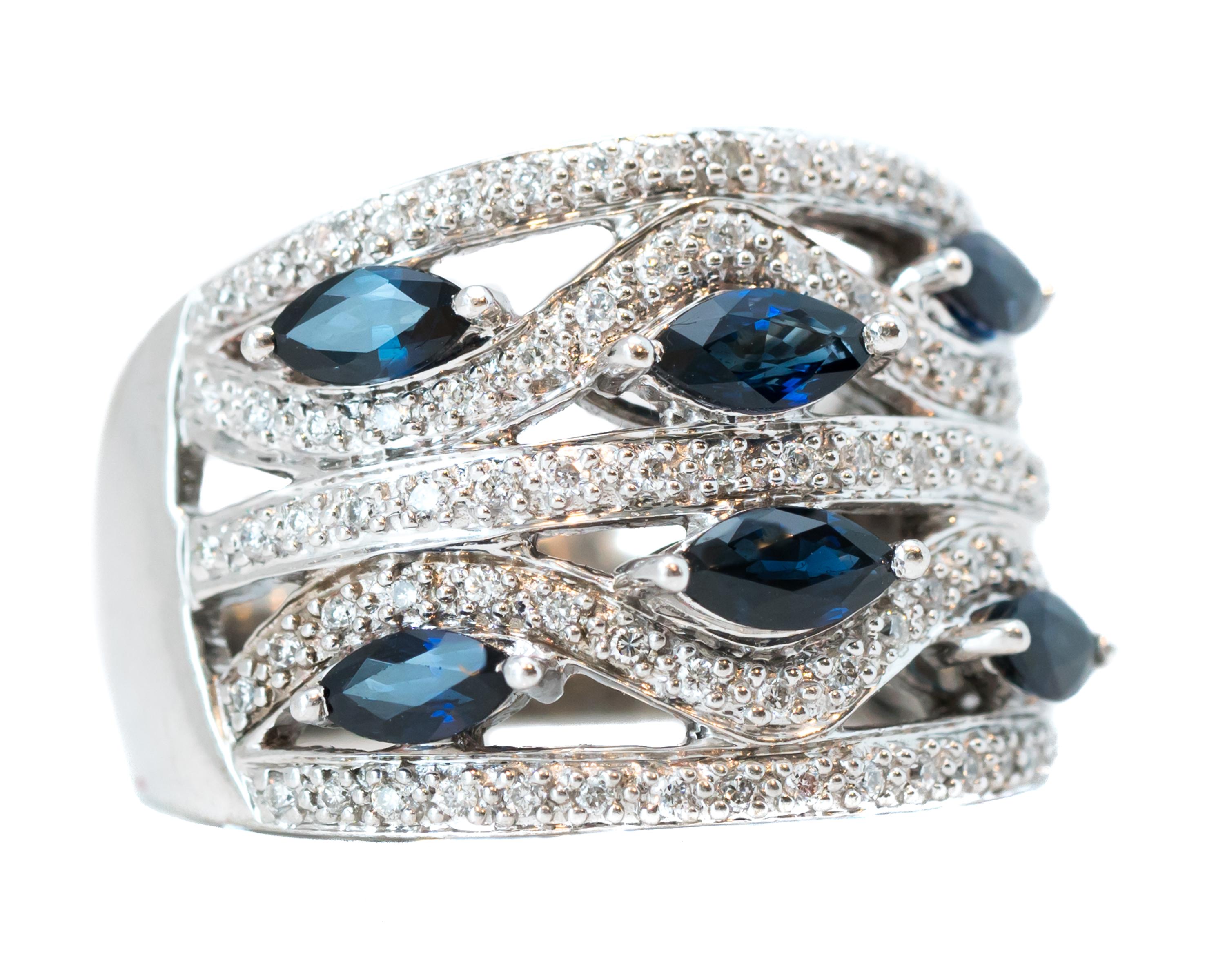 Features:
0.50 carat total Marquise cut Blue Sapphires and 0.50 carat total Round Brilliant Diamonds, all prong set
crafted in 14 karat White Gold setting

Finger to top of stone measures 4.25 millimeters
Width tapers from 16 - 4.5 millimeters
Ring