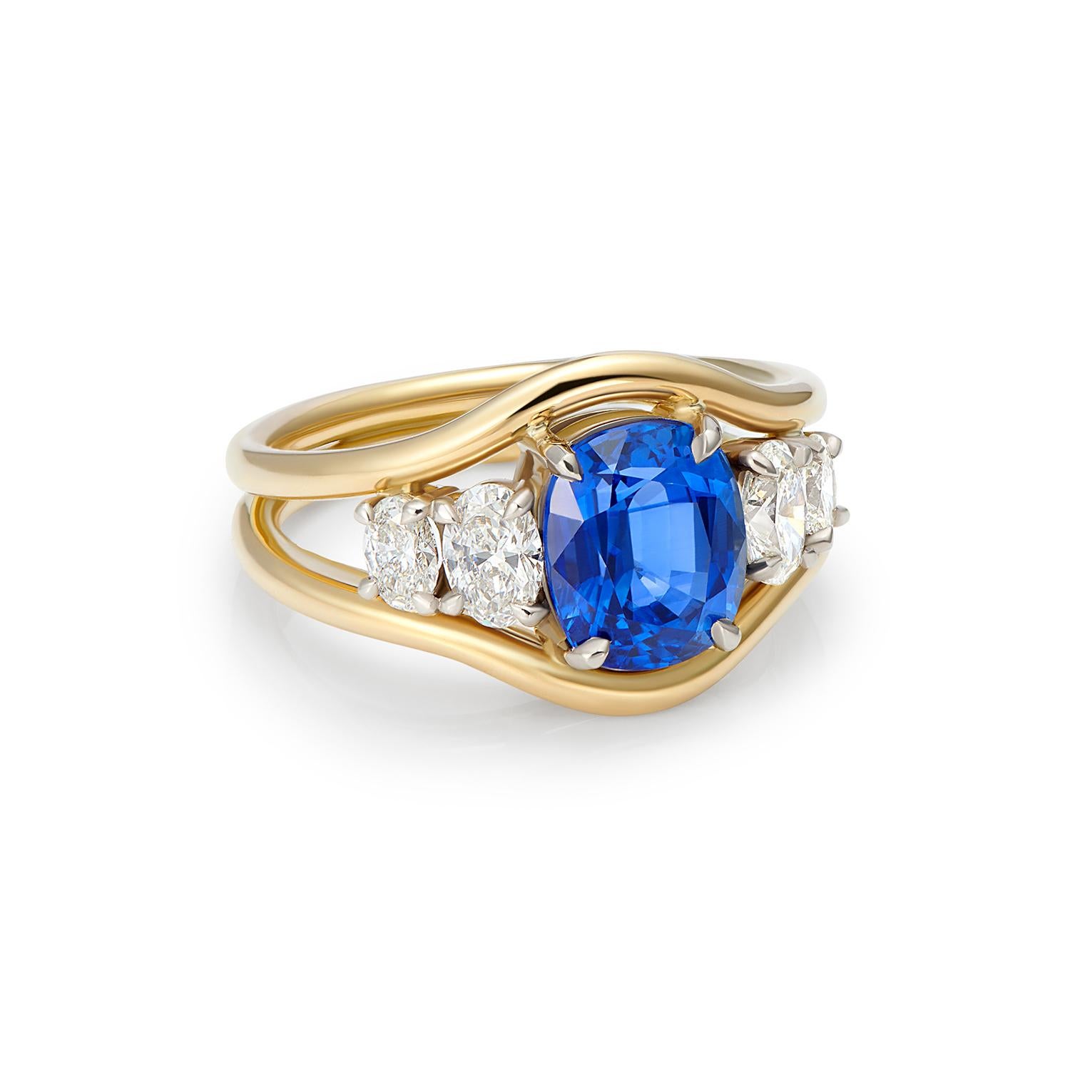 A spectacular cushion cut, Sri Lankan, no heat, blue sapphire set with 4 oval cut and white diamonds. This unique, one-of-a-kind statement ring is handmade in London in historic jewellery quarter, Hatton Garden. 


Sapphire: 3ct GIA