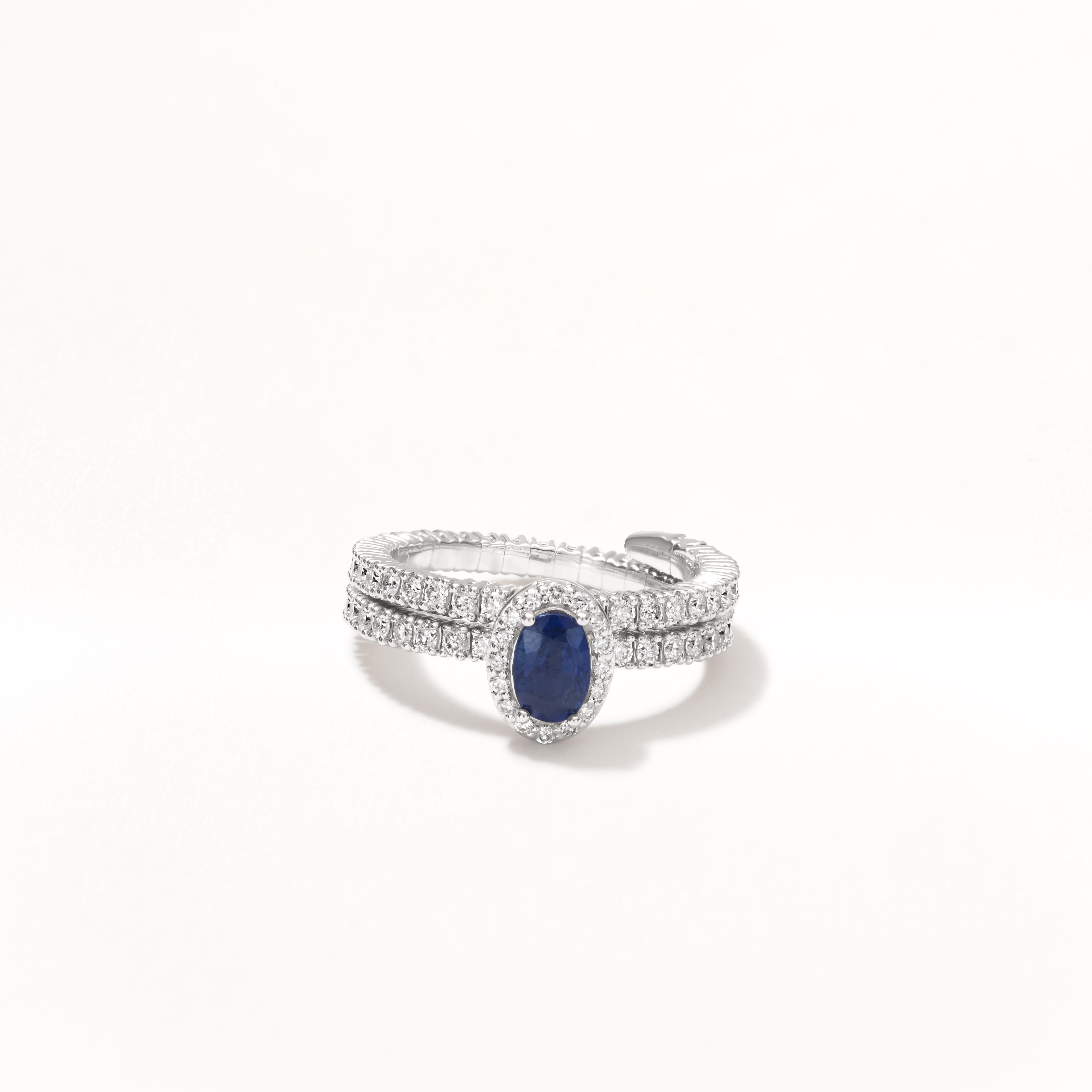 Adjustable and flexible, this ring can be worn on any finger you like. This 18k white gold adjustable band features an .59 ct. oval cut blue sapphire in a scintillating halo of round diamonds . The multi row shanks are studded with diamond making it