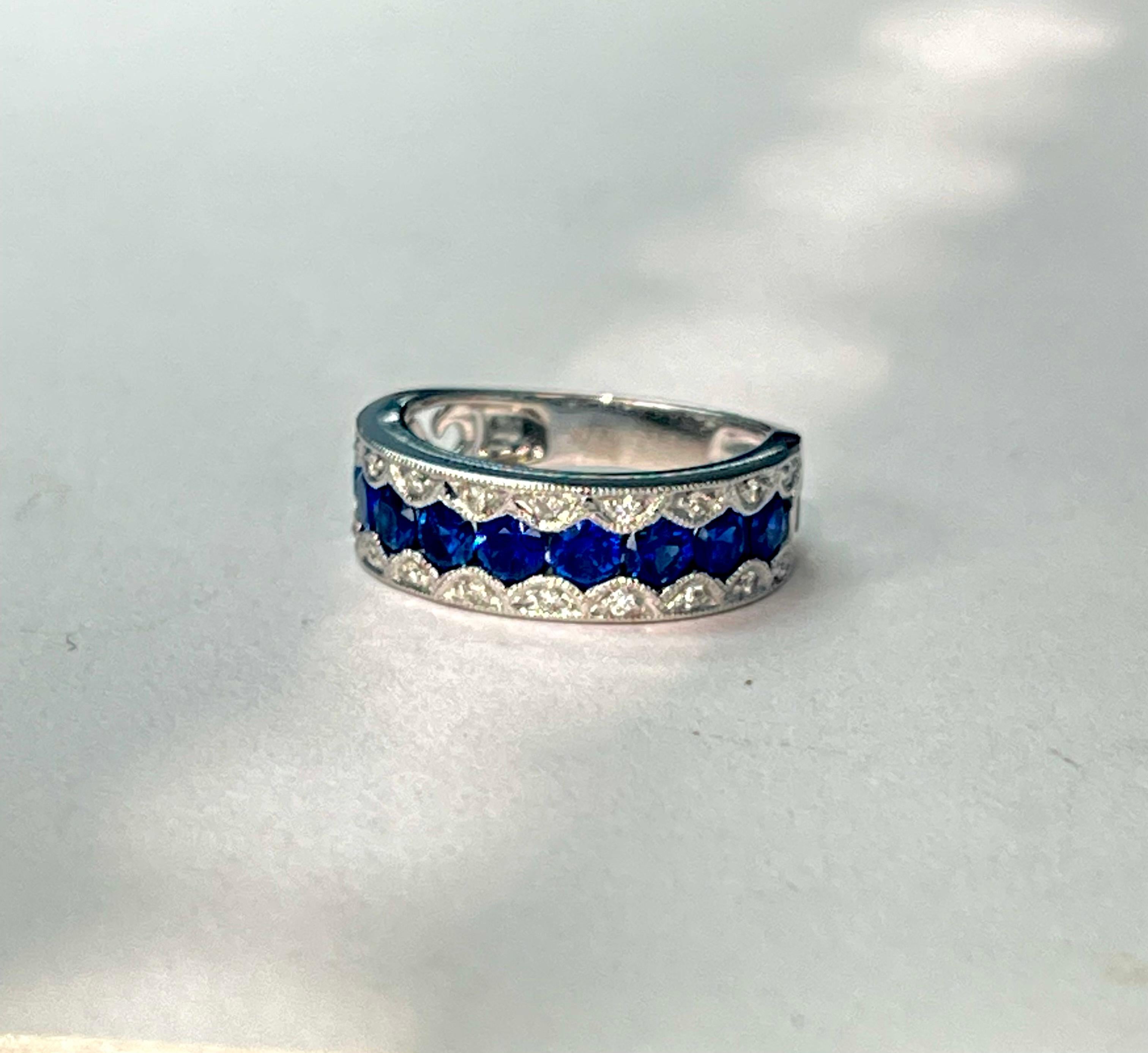 Blue sapphire and diamond band ring handcrafted in 18k white gold. 

The details are as follows : 
Blue sapphire weight : 1.41 carat 
Diamond weight : 0.15 carat ( G color and VS clarity ) 
Metal : 18k white gold 
Ring size : 6 1/2 


