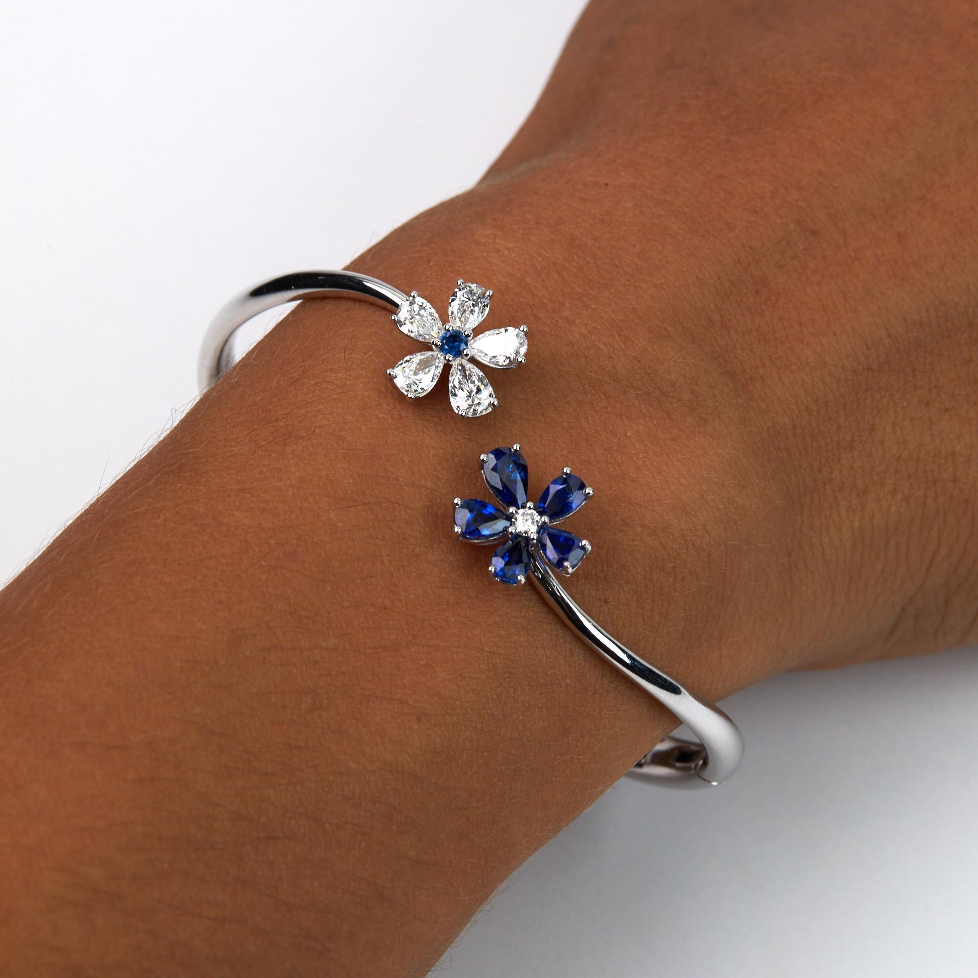 Blue Sapphire and Diamond Bangle Bracelet in a beautiful flora design.  The alternating Pear shaped Diamonds and Sapphires make up the petals of this modern bracelet from Italy. The Brilliant round cut sapphires and diamonds alternating make up the