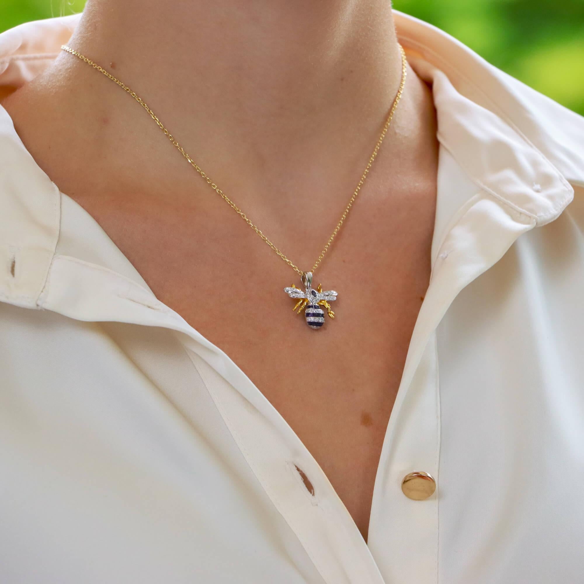  A beautiful sapphire and diamond bee pendant necklace set in 18k yellow and white gold.

The bee has been expertly handcrafted in England and is primarily set with French cut sapphires and round brilliant cut diamonds. The bee is further accented