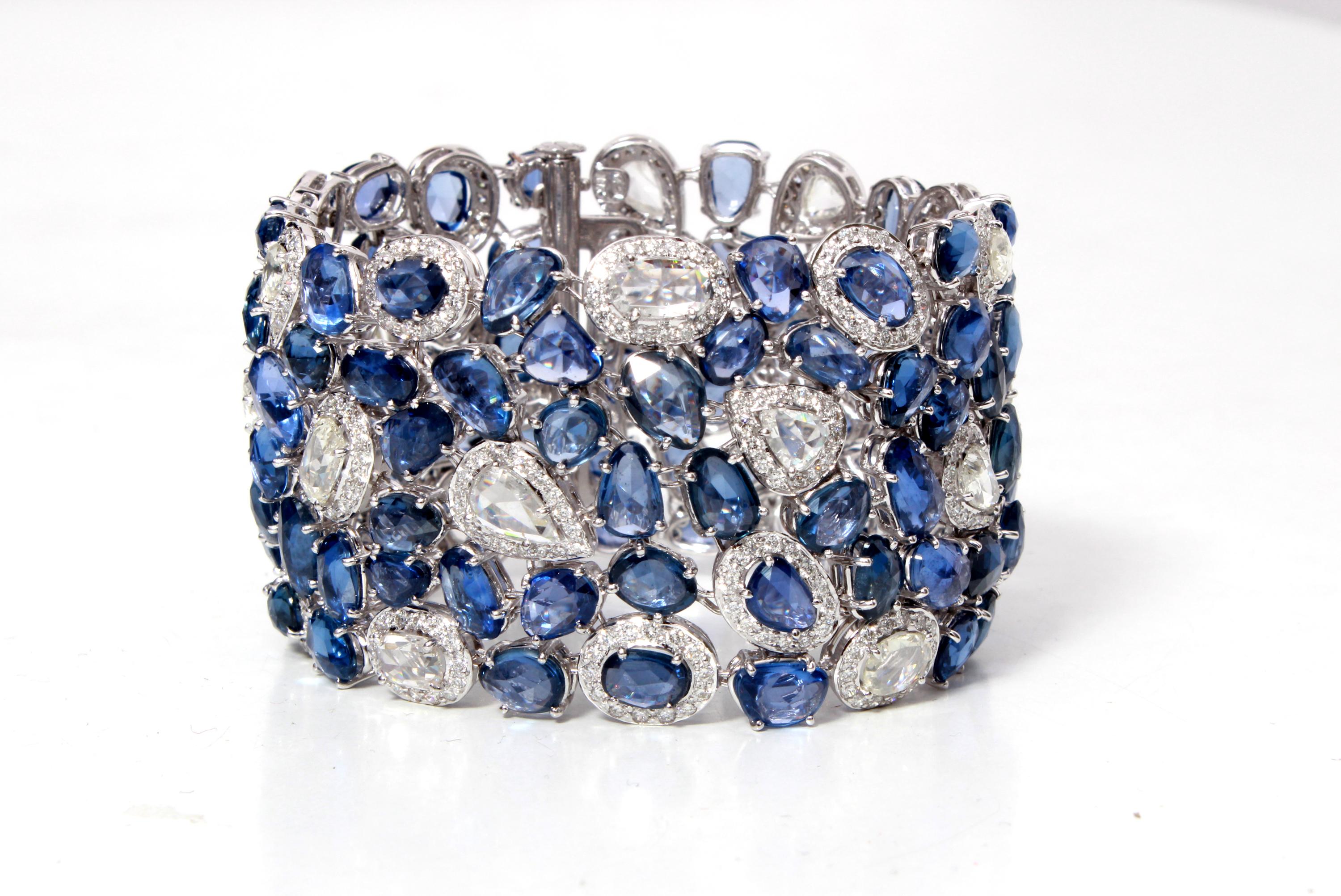 This astonishing bracelet mounted with 101 pieces of Rose Cut Blue Sapphires with weight of 94.28 carats, 439 Round Cut White Diamonds with weight of 5.48 carats and 18 Rose Cut White Diamonds with weight of 8.25 carats. The bracelet is made in 18K